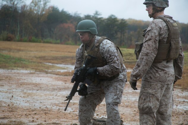 A Marine from Headquarters and Service Company, Marine Barracks Washington, D.C., stands at the alert before engaging targets with his M-16, service rifle, during a modified combat marksmanship shoot at range 14, Marine Corps Base Quantico, Va., Oct. 28, 2015.  The training helped the H&S Marines maintain proficiency on the range and reinforced perishable skills. (U.S. Marine Corps photo by Cpl. Skye Davis/Released)