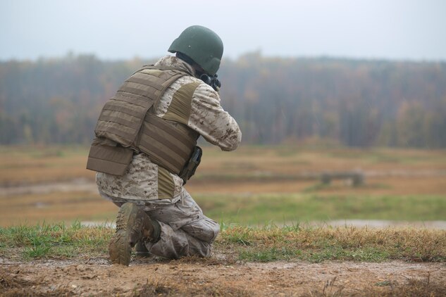 A Marine from Headquarters and Service Company, Marine Barracks Washington, D.C., fires an M-16, service rifle, during a modified combat marksmanship shoot at range 14, Marine Corps Base Quantico, Va., Oct. 28, 2015.  The training helped the H&S Marines maintain proficiency on the range and reinforced perishable skills. (U.S. Marine Corps photo by Cpl. Skye Davis/Released)