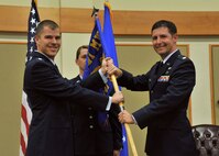 Maj. Jeremiah Kirschman, right, accepts command of the 341st Contracting Squadron from Lt. Col. Scott Fleming, 341st Mission Support Group deputy commander Oct. 29, 2015, at Malmstrom Air Force Base, Mont. Senior Master Sgt. Toni Wiser, 341st CONS superintendent, center, looks on. (U.S. Air Force photo/John Turner)