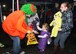 Peggy Brooks gives candy to Elena Lefebvre during a Fall Festival and Trunk or Treat event at the base chapel Oct. 28, as her mother, Laurene Lefebvre, and brother, Nathan Lefebvre, look on. The Hanscom chapel in partnership with Family Advocacy Program hosted the event for members of the community. (U.S. Air Force photo by Mark Herlihy)