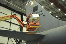 U.S. Air Force Staff Sgt. Adam Denham, 100th Maintenance Squadron aircraft structural maintenance craftsman, uses a boom lift to place the “D” decal on top of a black square to form the “Square D” on the tail of a KC-135 Stratotanker Oct. 21, 2015, on RAF Mildenhall, England. The jet, formerly from McConnell Air Force Base, Kan., has been reassigned to RAF Mildenhall and underwent a full isochronal inspection. The jet has now been repainted and given the Square D markings. (U.S. Air Force photo by Karen Abeyasekere/Released)