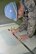 U.S. Air Force Staff Sgt. Adam Denham, 100th Maintenance Squadron aircraft structural maintenance craftsman, draws lines on the paper lay of the “D” decal in order to pinpoint the center, ensuring it goes in exactly the right place when positioned on the tail of a KC-135 Stratotanker Oct. 21, 2015, on RAF Mildenhall, England. Once placed in position on top of the black square, the two form the “Square D.” The aircraft was reassigned to the 100th Air Refueling Wing from McConnell Air Force Base, Kan., and arrived mid-September. (U.S. Air Force photo by Karen Abeyasekere/Released)