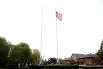 U.S. Air Force Airmen from the 100th Air Refueling Wing participate in a retreat ceremony Oct. 29, 2015, on RAF Mildenhall, England. A retreat ceremony, during which the U.S. and Royal Air Force flags are retired, takes place on the last duty day of every month. (U.S. Air Force photo by Senior Airman Kate Thornton/Released)