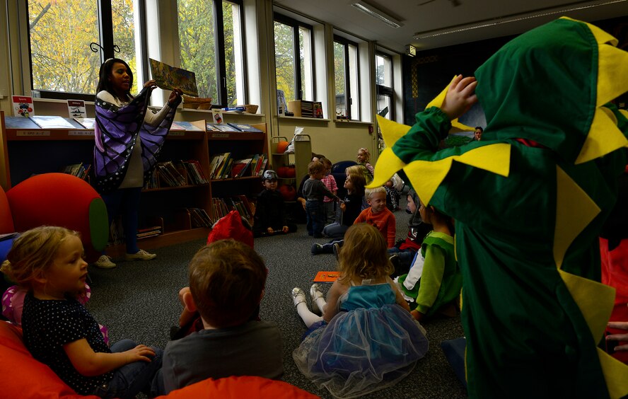 Terina Curtis, library technician at the Ramstein Library, reads a story to children during Spooky Story Time Oct. 29, 2015, at Ramstein Air Base, Germany. Curtis read two Halloween-themed stories for the children. (U.S. Air Force photo/Airman 1st Class Tryphena Mayhugh)