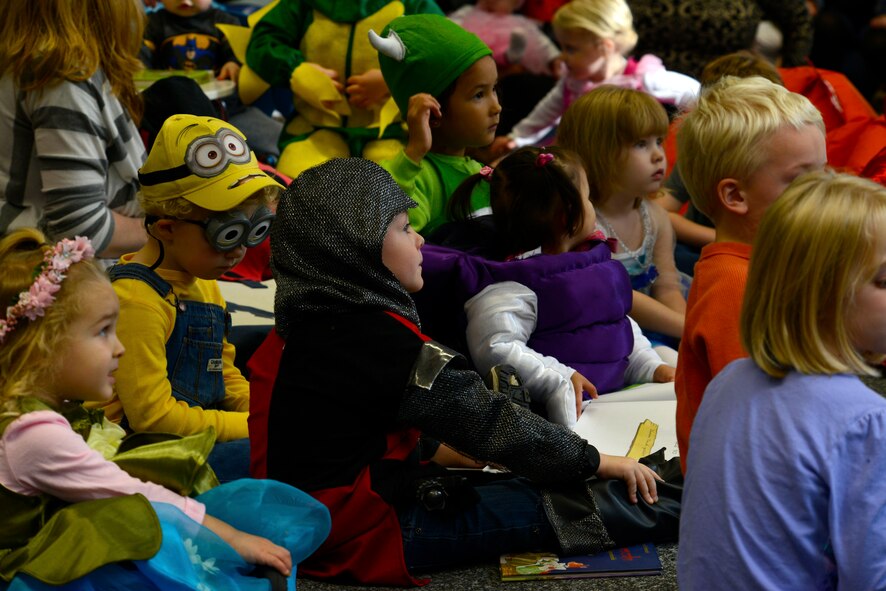 Kaiserslautern Military Community children listen to a story during the Ramstein Library’s Spooky Story Time Oct. 29, 2015, at Ramstein Air Base, Germany. The children were encouraged to wear a Halloween costume to the event. (U.S. Air Force photo/Airman 1st Class Tryphena Mayhugh)