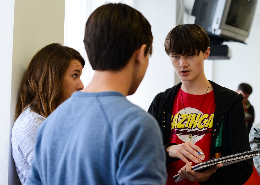 Aviano High School robotics club members discuss robot designs during a robotics club session, Sept. 30, 2015, at Aviano Air Base, Italy. The whole team participates in each stage of the building process to encourage students to share their ideas with one another. (U.S. Air Force photo by Senior Airman Austin Harvill/Released)