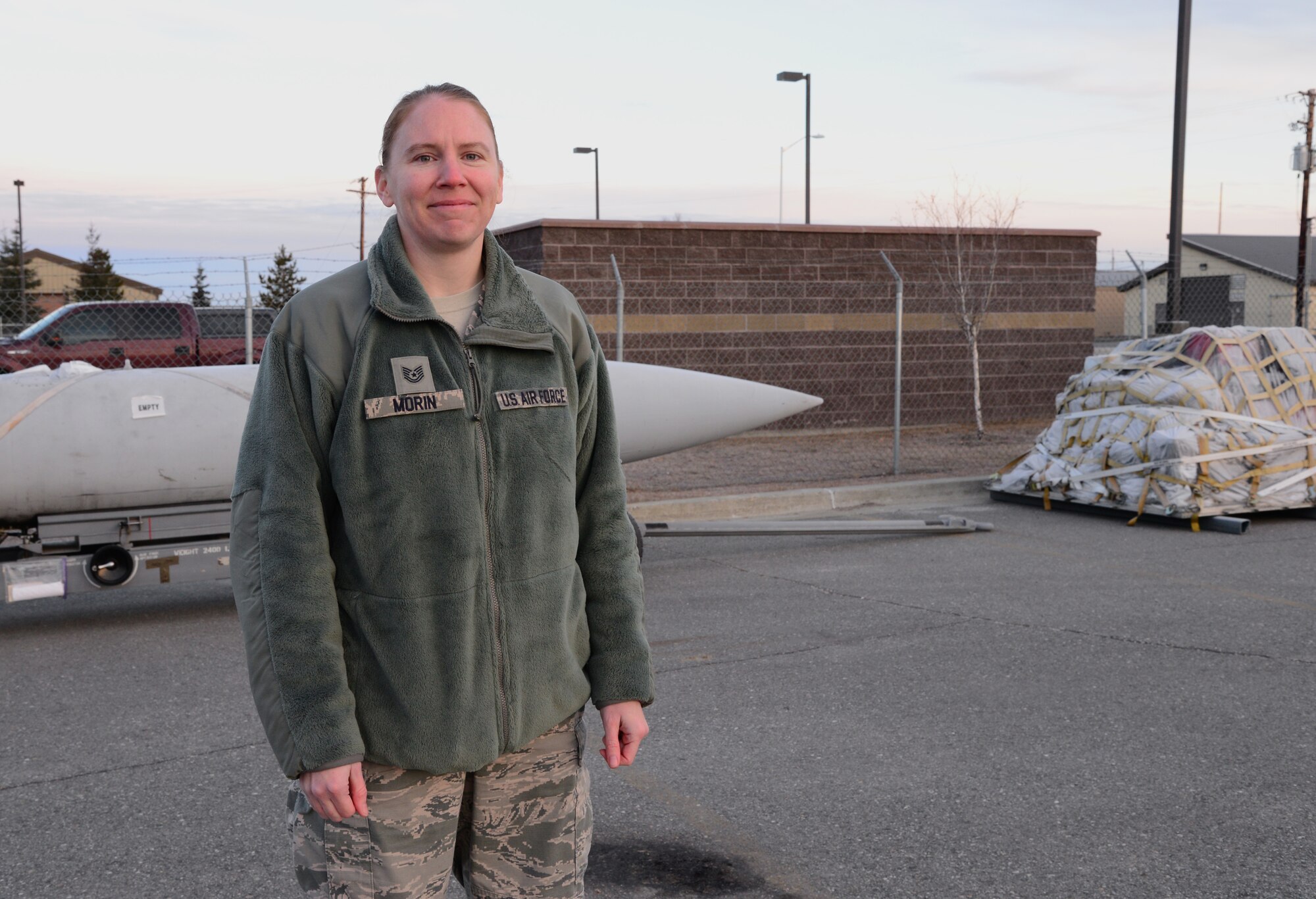U.S. Air Force Tech. Sgt. Rebecca Morin, the 354th Logistics Readiness Squadron noncommissioned officer in charge of air terminal operations, takes a break while working on cargo Oct. 28, 2015, at Eielson Air Force Base, Alaska. Morin said her favorite part of her job is loading and securing cargo in an aircraft. (U.S. Air Force photo by Airman 1st Class Cassandra Whitman/Released)