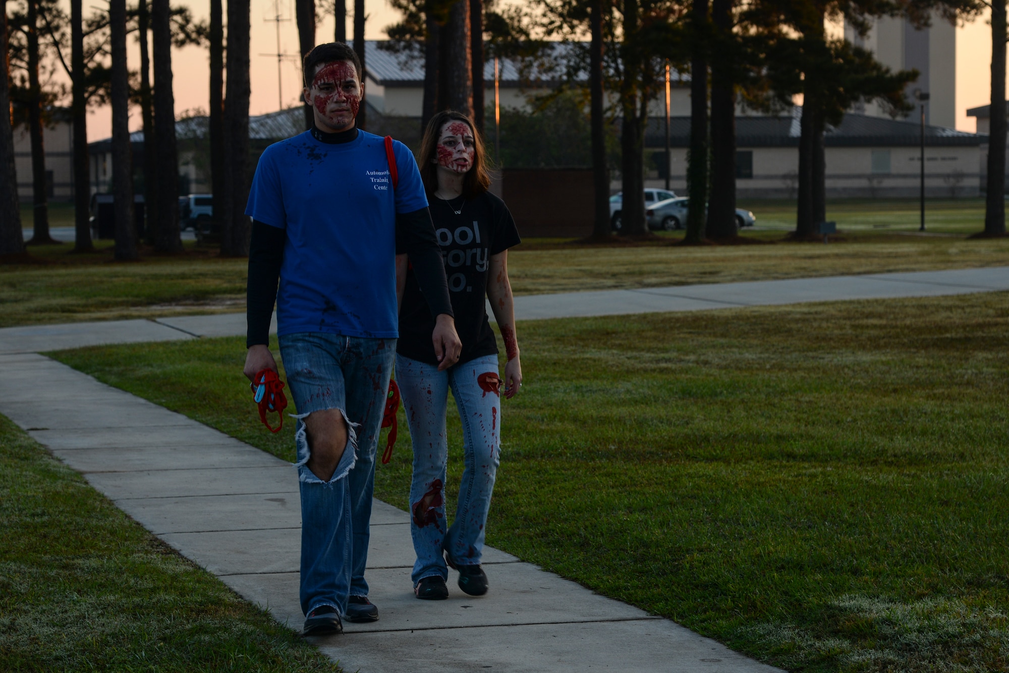 U.S. Air Force Airman 1st Class Jarid Kreiser and his wife, Amber, shuffle back to the starting line after the Zombie Run Oct. 30, 2015, at Moody Air Force Base, Ga. Runners were given two flags, representing runners’ lives,  zombies had to take during the 5K run. (U.S. Air Force photo by Airman 1st Class Janiqua P. Robinson/Released)