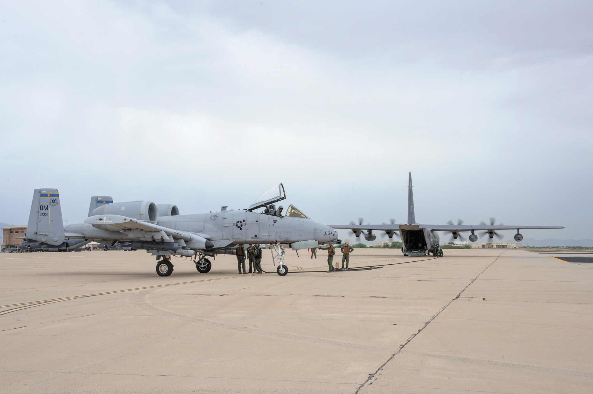 A U.S. Air Force A-10C Thunderbolt II from the 354th Fighter Squadron takes on fuel from an HC-130J Combat King II from the 79th Rescue Squadron during Forward Area Refueling Point training at Davis-Monthan Air Force Base, Ariz., Oct. 15, 2015. This is the first time an A-10 has been refueled via FARP at D-M. (U.S. Air Force photo by Senior Airman Chris Massey/Released) 
