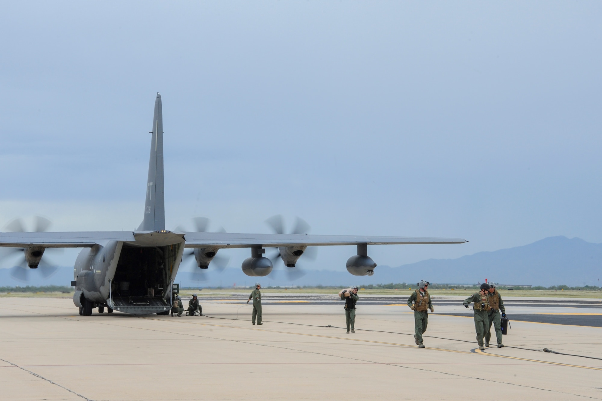U.S. Airmen with the 355th Logistics Readiness Squadron and 563rd Operations Support Squadron Forward Area Refueling Point team deploy equipment from an HC-130J Combat King II needed to refuel an A-10C Thunderbolt II during FARP training at Davis-Monthan Air Force Base, Ariz., Oct. 15, 2015.  The FARP team is an Air Combat Command program that trains, organizes and equips LRS personnel in the conduct of forward refueling operations in support of worldwide contingencies. (U.S. Air Force photo by Senior Airman Chris Massey/Released)