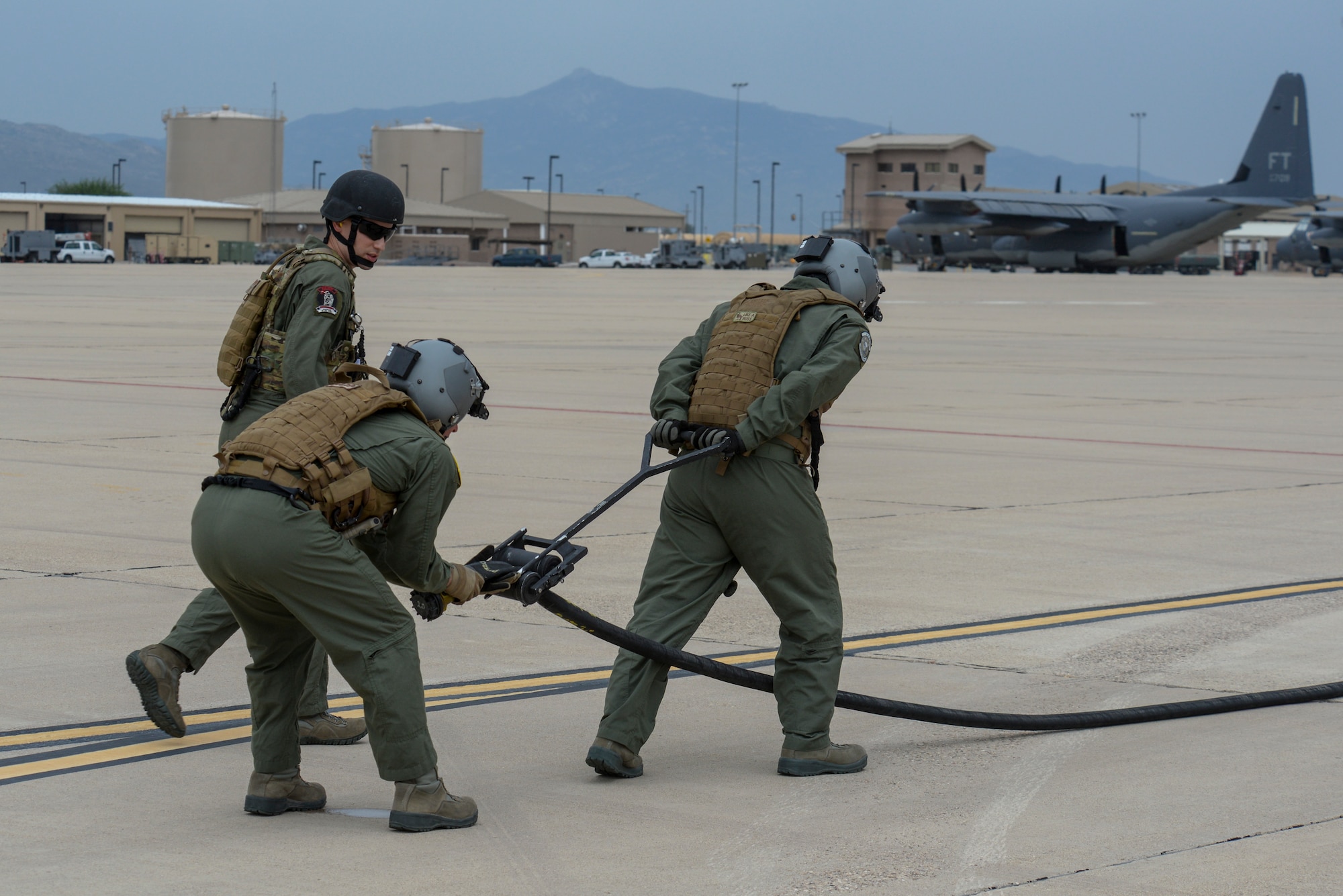 U.S. Air Force Staff Sgts. Uriah Hale-Huskon and Timothy Quinn, 355th Logistics Readiness Squadron and 563rd Operations Support Squadron Forward Area Refueling Point team members, set up a squeegee to help defuel a FARP hose during training at Davis-Monthan Air Force Base, Ariz., Oct. 15, 2015. The FARP capability allows for projection of combat power and rescue forces from an infinite number of locations around the world. (U.S. Air Force photo by Senior Airman Chris Massey/Released)