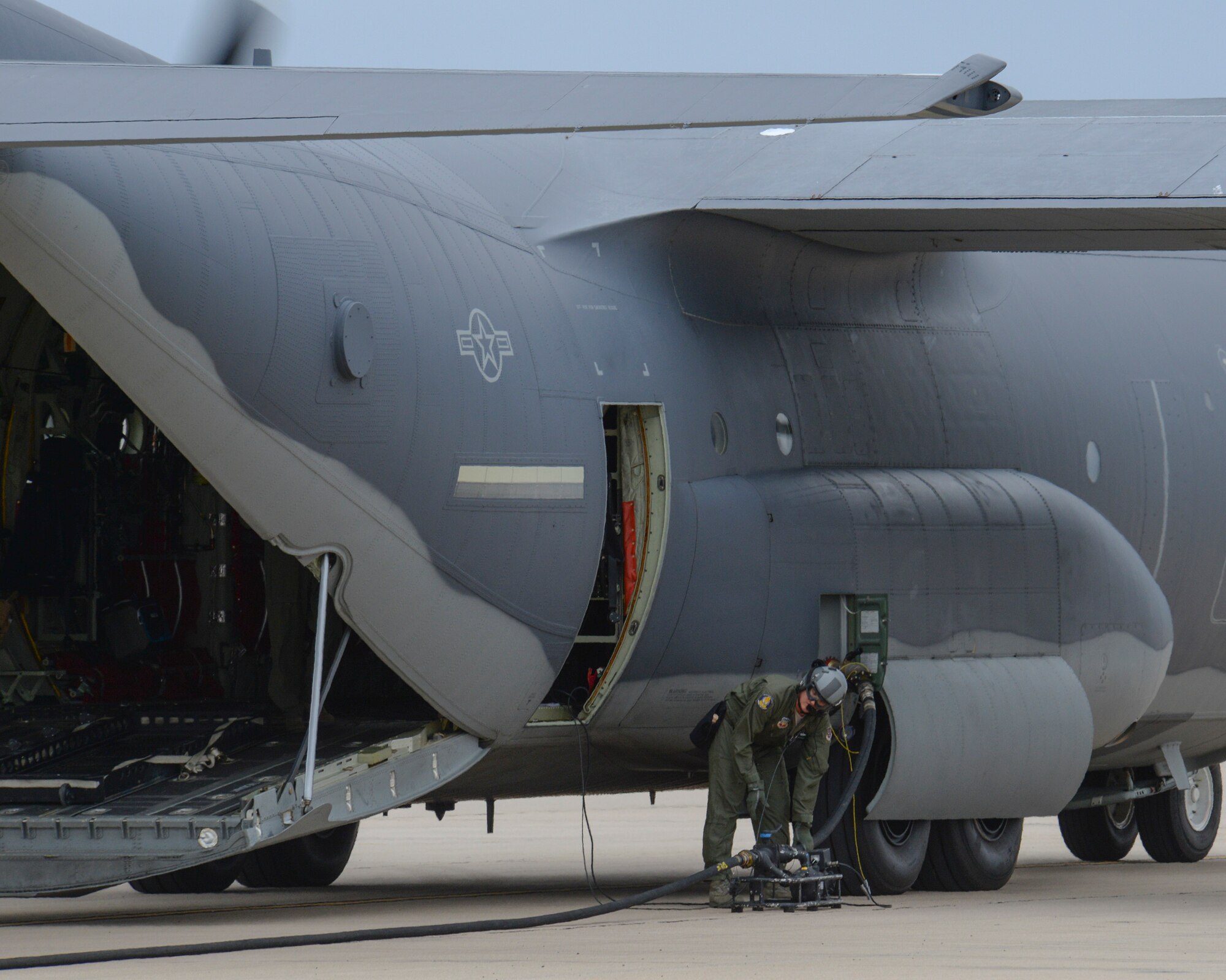 U.S. Air Force Master Sgt. Michael Mueller, 79th Rescue Squadron loadmaster, sets up a defuel pump connected to an HC-130J Combat King II during Forward Area Refueling Point training at Davis-Monthan Air Force Base, Ariz., Oct. 15, 2015. The FARP capability allows for projection of combat power and rescue forces from an infinite number of locations around the world. (U.S. Air Force photo by Senior Airman Chris Massey/Released)