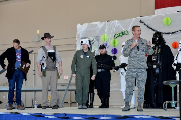 Col. Case Cunningham, 432nd Wing/432nd Air Expeditionary Wing commander, addresses the audience during the 2015 Children’s Halloween party Oct. 30, 2015, at Creech Air Force Base, Nevada. Activities for the day included cornhole, trunk or treat, book reading, free food, bag decoration, and a magic show. (U.S. Air Force photo by Senior Airman Adarius Petty/Released)