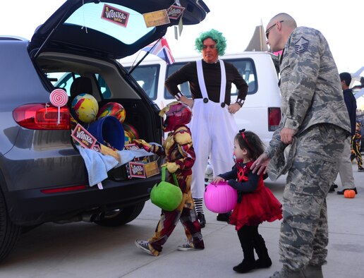 Graydon, six, and Paisley, two, children of Master Sgt. Alan Turner, 799th Air Base Squadron section chief of engineering, participate in a 'trunk or treat' during the 2015 children's Halloween party Oct. 30, 2015, at Creech Air Force Base, Nevada. Activities for the day included cornhole, trunk or treat, book reading, free food, bag decoration, and a magic show. (U.S. Air Force photo by Airman 1st Class Christian Clausen/Released)