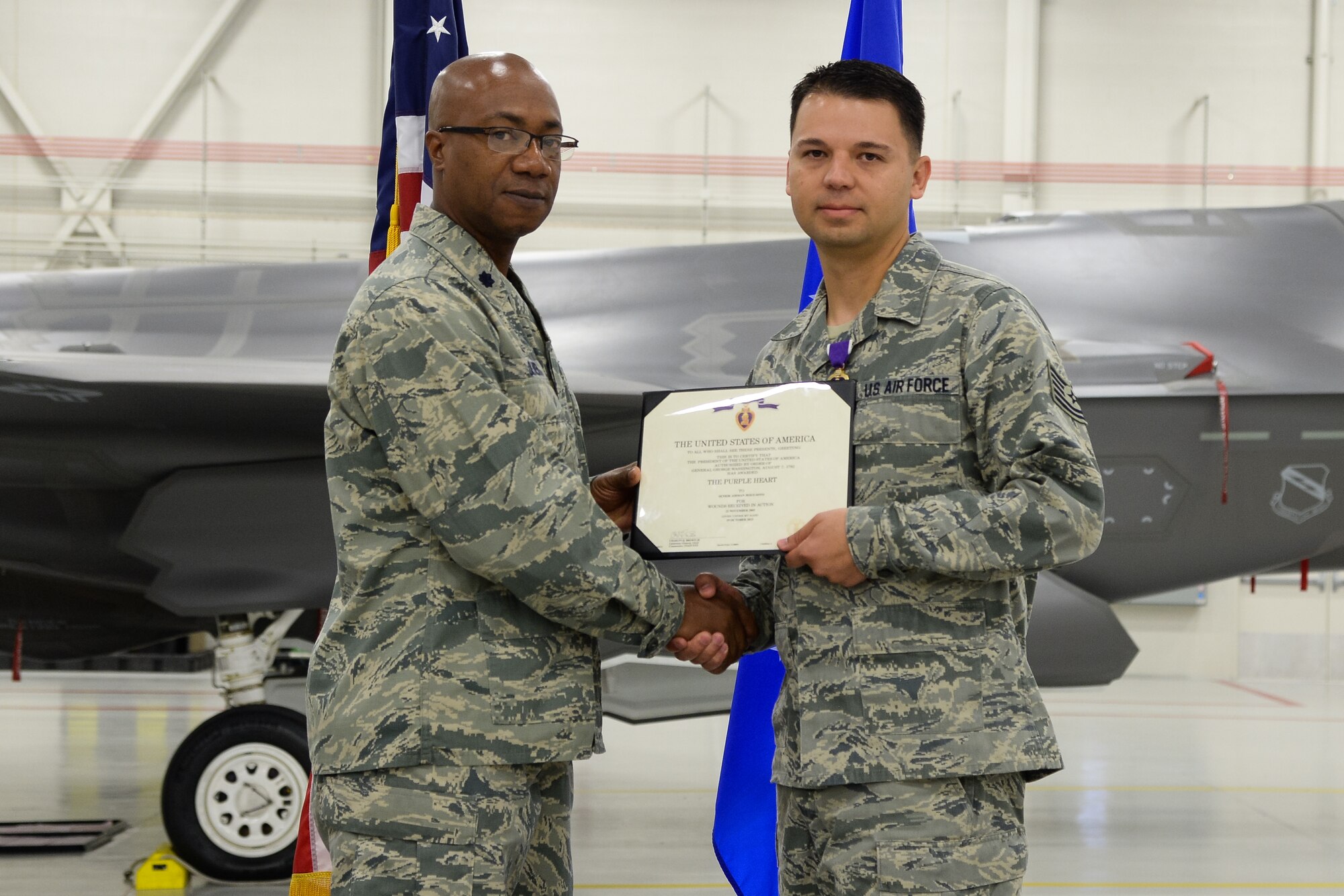 Electronic Warfare Specialist Tech Sgt. Jesus Soto receives a Purple Heart from 388th Component Maintenance Sqaudron Commander Lt. Col. Steven Oliver at Hill Air Force Base, Utah, Oct. 30, 2015. Soto was injured in 2005 while deployed with the 1st Security Forces Squadron to Forward Operating Base Speicher near Tikrit, Iraq. While there, he provided security to U.S. convoys and foreign national supply trucks. (U.S. Air Force photo by R. Nial Bradshaw/Released)