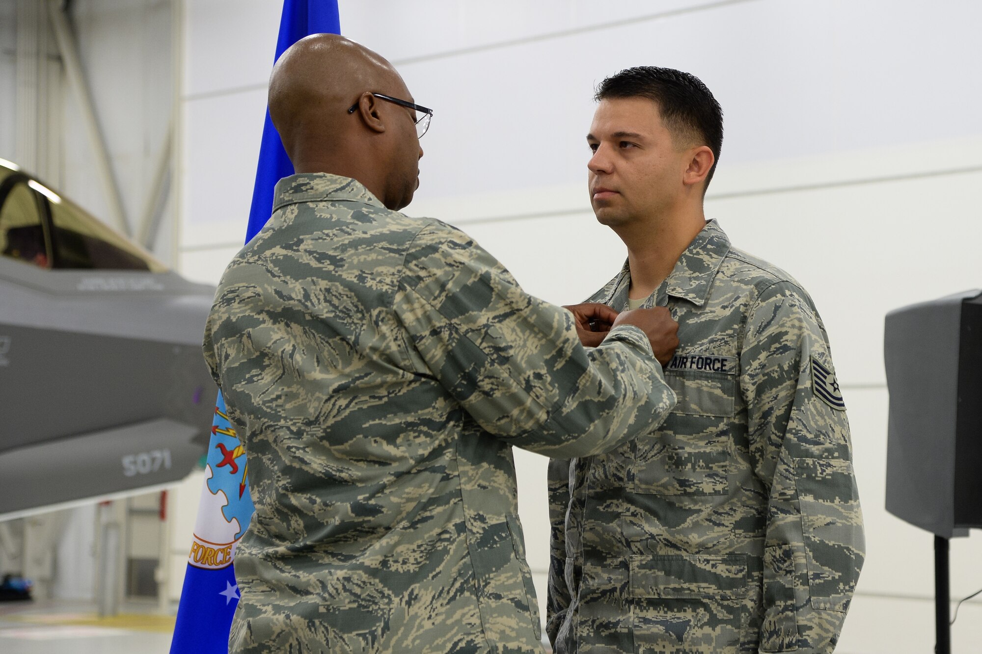 Electronic Warfare Specialist Tech. Sgt. Jesus Soto receives a Purple Heart from 388th Component Maintenance Sqaudron Commander Lt. Col. Steven Oliver at Hill Air Force Base, Utah, Oct. 30, 2015. Soto was injured in 2005 while deployed with the 1st Security Forces Squadron to Forward Operating Base Speicher near Tikrit, Iraq. While there, he provided security to U.S. convoys and foreign national supply trucks. (U.S. Air Force photo by R. Nial Bradshaw/Released)