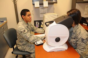 Senior Airman Aalona Chandler performs an eye examination on a member of the 127th Wing at Selfridge Air National Guard Base, Mich., Oct. 17, 2015. Chandler, an optometry technician with the 127th Medical Group, said almost every member of the Wing eventually has to see him for an eye exam, giving him an appreciation for the diversity that exists in the Wing. (U.S. Air National Guard photo by Staff Sgt. Samara Taylor)