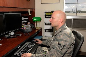 Staff Sgt. Nick Smith works at his desk with the 127th Logistics Readiness Squadron at Selfridge Air National Guard Base, Oct. 17, 2015. After serving for several years on active duty, the Airman wanted to return home but continue to serve. He found his opportunity in the Michigan Air National Guard. (U.S. Air National Guard photo by Master Sgt. David Kujawa)