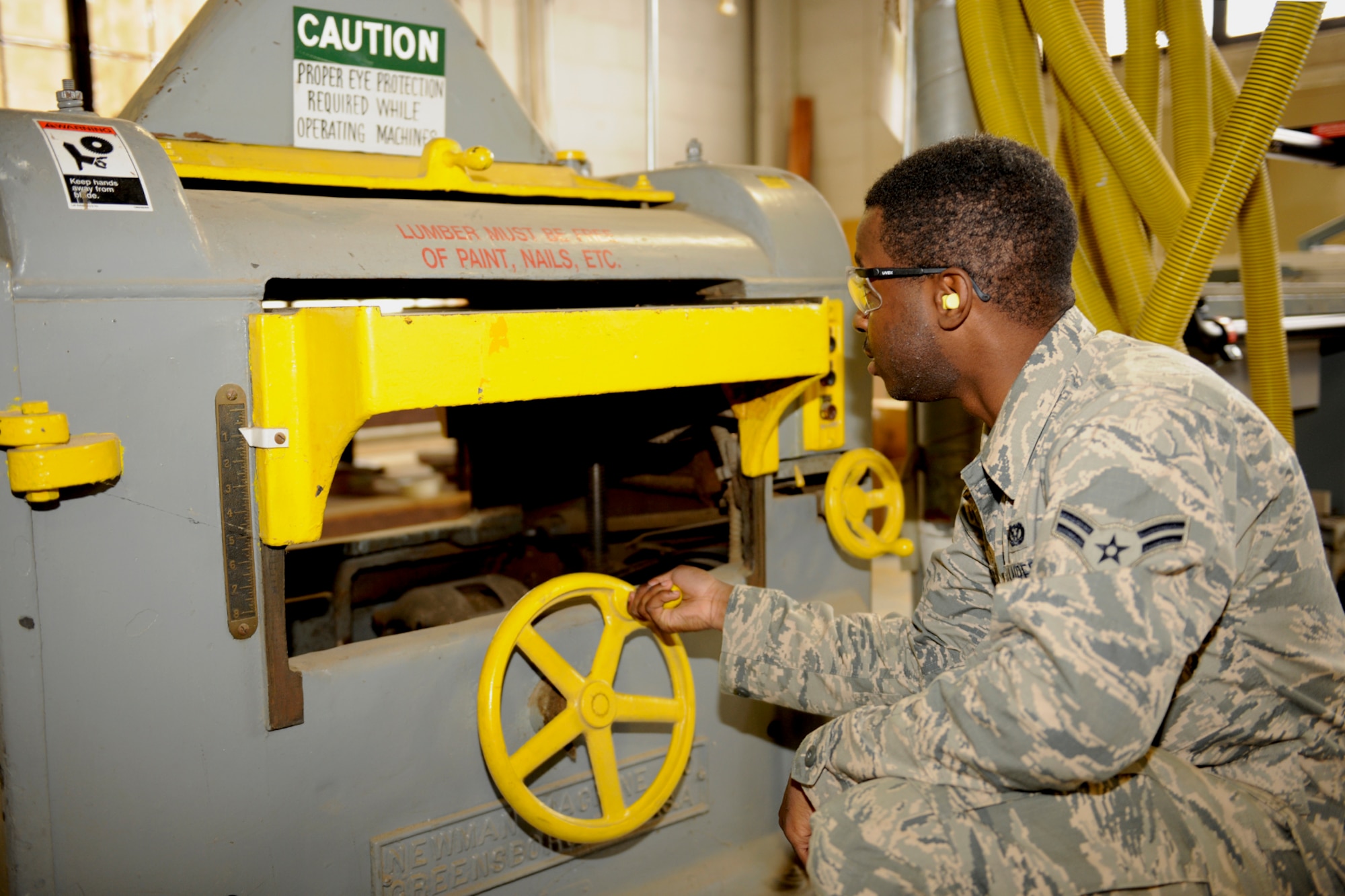151017-Z-EZ686-021 – Airman 1st Class John Pitts of the 127th Civil Engineering Squadron, Selfridge Mich., is making adjustment on the work shop planer, used for resurfacing wood at Selfridge Air National Guard Base Mich., October 17, 2015.  Pitts is a newly affiliated member of the CE Squadron, who recently graduated from technician school where he learned the art of working on buildings and structures.  (U.S. Air National Guard photo by MSgt. David Kujawa/Released)