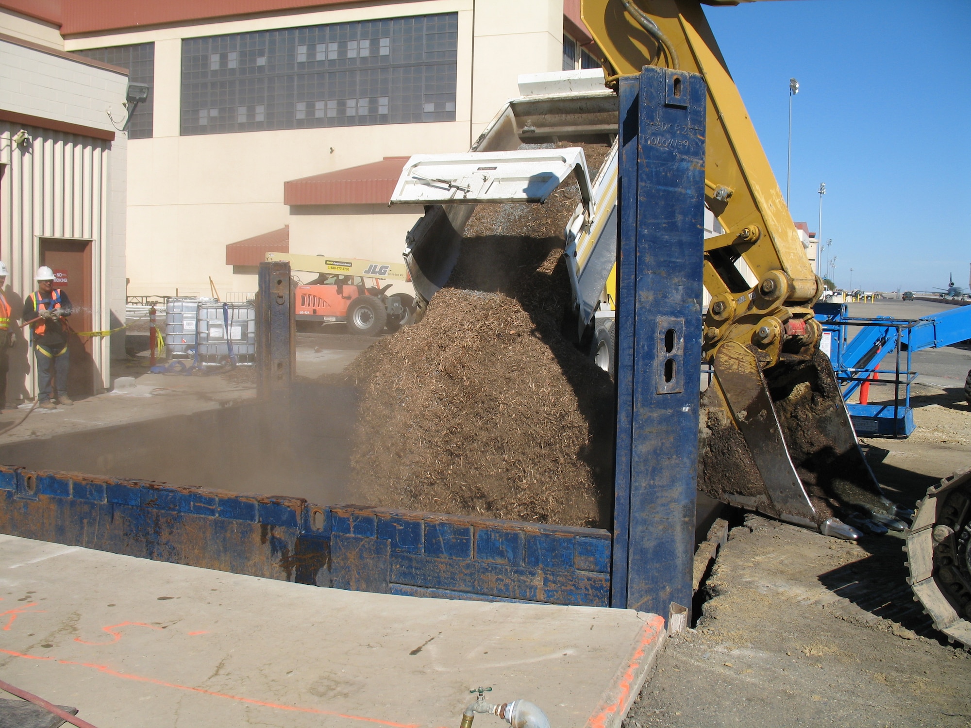 Environmental cleanup contractors backfill a bioreactor with organic mulch and gravel. The system acts like an underground coffee percolator promoting the growth of solvent-eating microbes that breakdown solvents into harmless substances. (Courtesy photo)