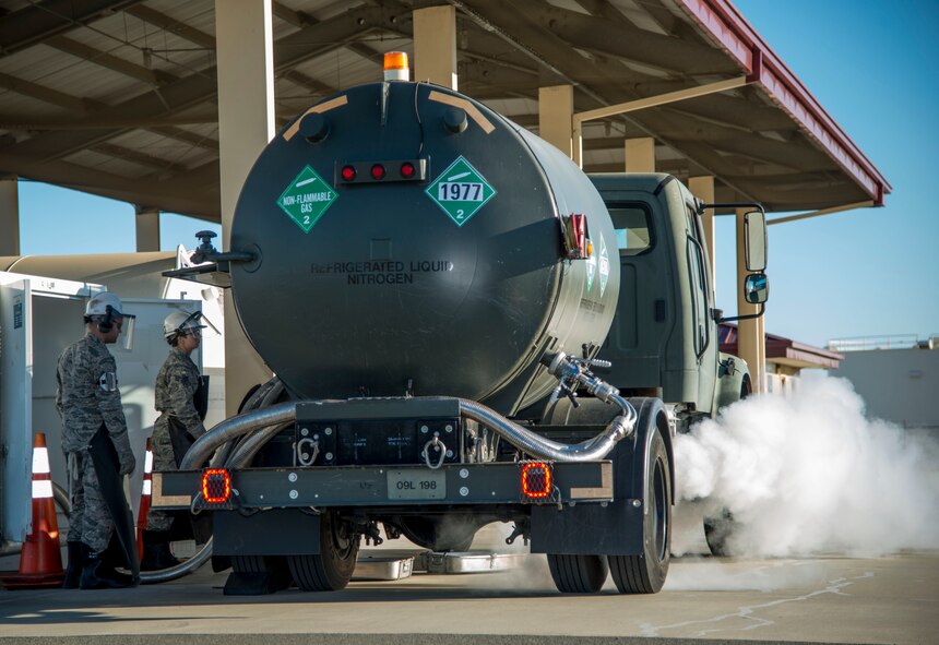 Senior Airman Sarina Trego, 60th Logistics Readiness Squadron cryogenics technician, fills a liquid nitrogen truck for Senior Airman Damien Gish, 60th Aircraft Maintenance Squadron C-5M Super Galaxy crew chief, to service the aircraft Oct. 20 at Travis Air Force Base, Calif. Liquid oxygen is used to pressurize an aircraft and allow the aircrew to breath while flying while liquid nitrogen is used as a fire suppressant. (U.S. Air Force photo by Senior Airman Nicole Leidholm)