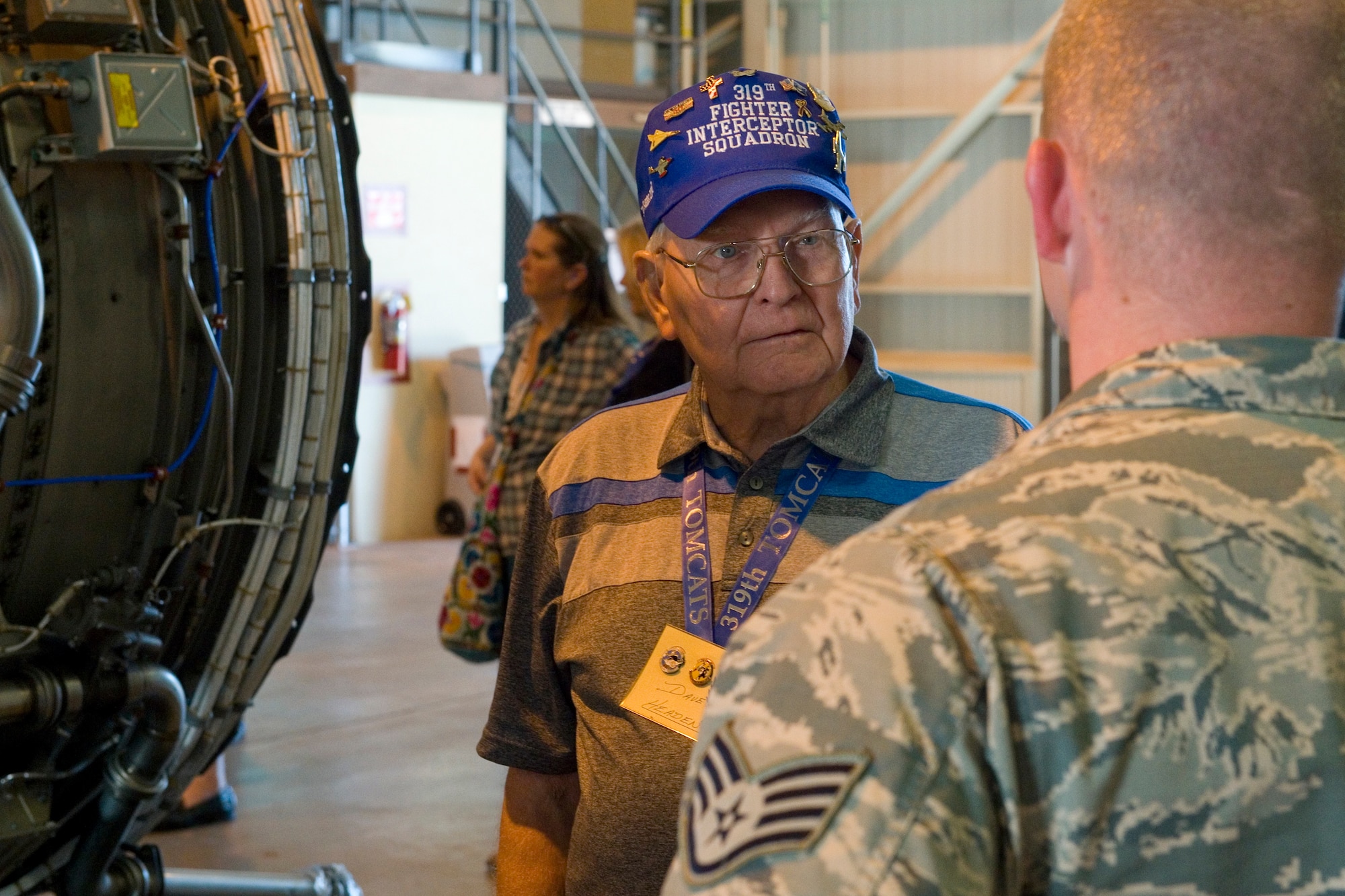 David Headen, 319th Fighter Interceptor Squadron Association member, speaks to Staff Sgt. Michael Meoak, 434th Maintenance Squadron aerospace propulsion journeyman, during a tour at Grissom Air Reserve Base, Ind., Sept. 25, 2015. The tour was part of the association's 24th reunion and included a visit to Grissom's jet engine shop and a tour of a KC-135R Stratotanker. (U.S. Air Force photo/Tech. Sgt. Benjamin Mota)