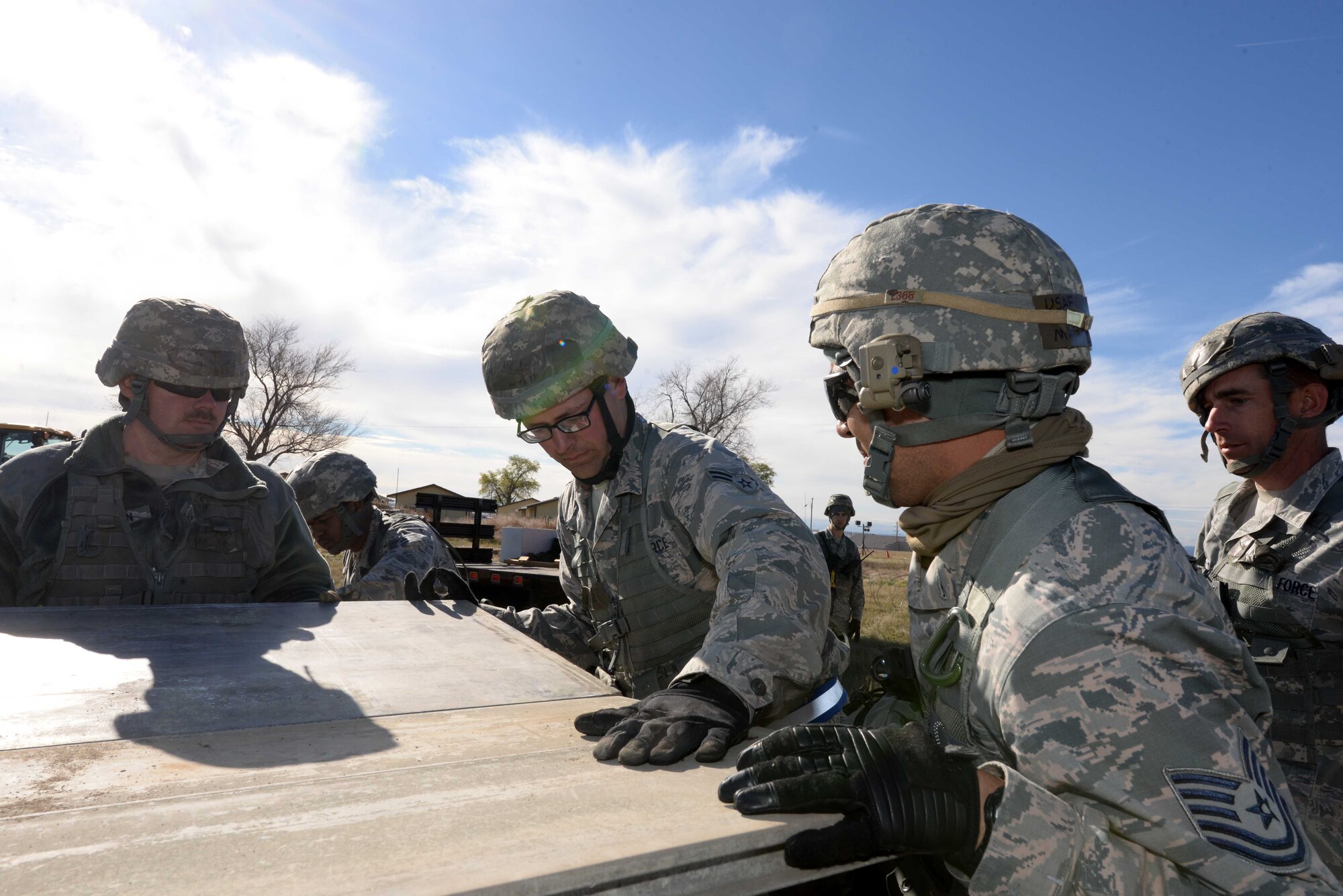 Airmen from the 28th Civil Engineer Squadron build an entry control point for a forward operating base during a base operational readiness exercise at Ellsworth Air Force Base, S.D., Oct. 20, 2015. The exercise provided Airmen an opportunity to train for real-world contingencies in a deployed environment. (U.S. Air Force photo by Senior Airman Rebecca Imwalle/Released)