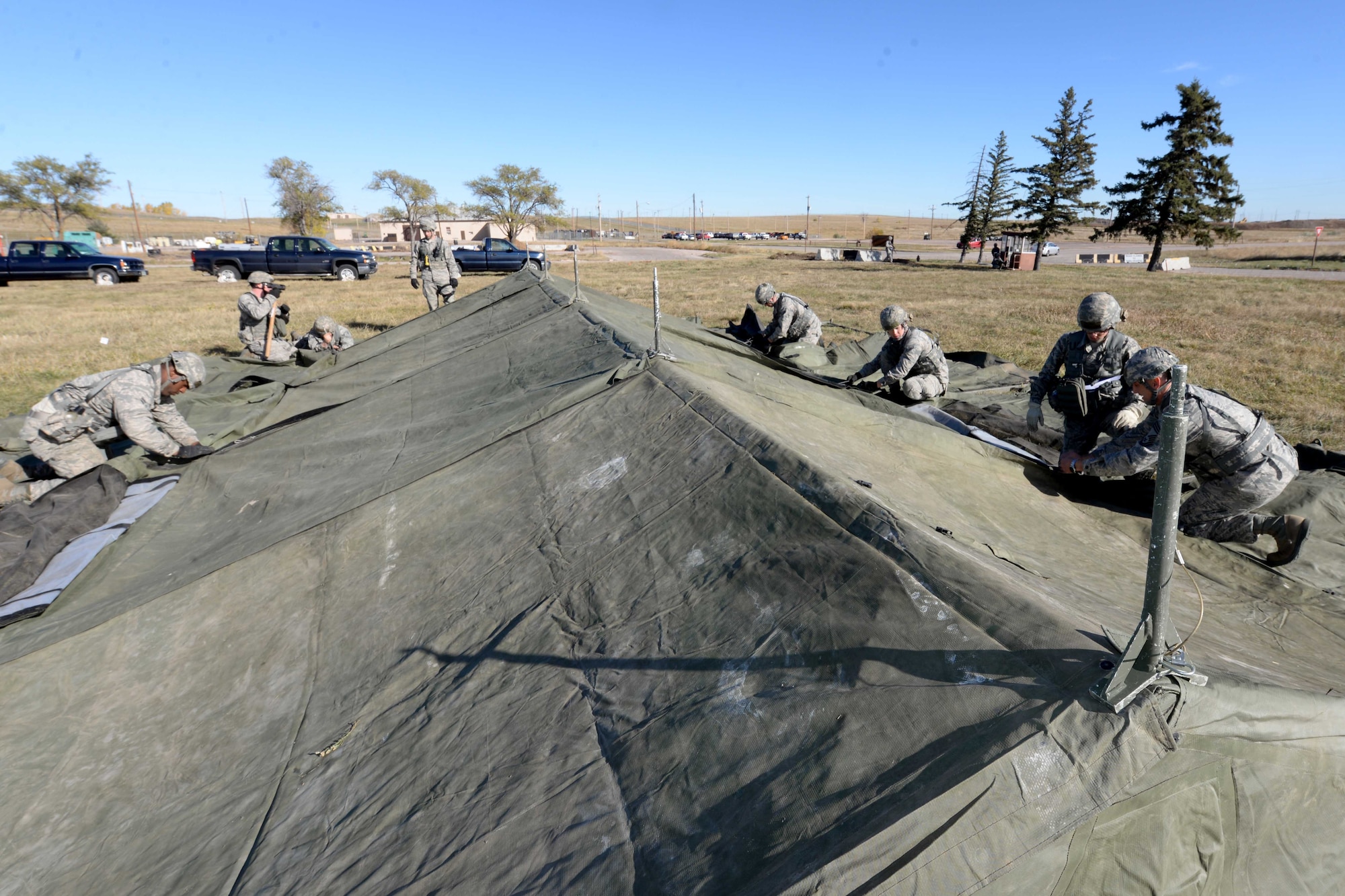 Airmen from the 28th Civil Engineer Squadron build a temper tent during a base operational readiness exercise at Ellsworth Air Force Base, S.D., Oct. 20, 2015. Base operational readiness exercises evaluate the wing's ability to meet wartime and contingency tasks of employing and sustaining forces, and maintaining the ability to survive and operate in a deployed location. (U.S. Air Force photo by Senior Airman Rebecca Imwalle/Released)