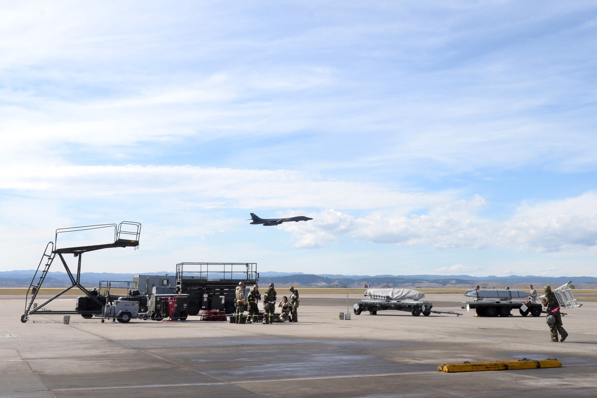 Airmen from the 28th Aircraft Maintenance Squadron participate in a base operational readiness exercise while a B-1 bomber is launched at Ellsworth Air Force Base, S.D., Oct. 20, 2015. The exercise evaluated several units that support the operational mission at Ellsworth, and included aircraft maintenance, simulated damage assessment, and how to respond to a Chemical, Biological, Radiological, Nuclear, and High Yield Explosives reconnaissance threat among other capabilities. (U.S. Air Force photo by Senior Airman Rebecca Imwalle/Released)