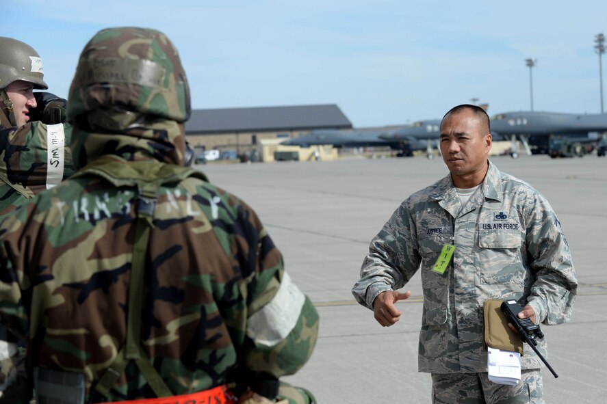 Senior Master Sgt. Jason Justice, 28th Aircraft Maintenance Squadron aircraft section superintendent, speaks with Airmen during a base operational readiness exercise at Ellsworth Air Force Base, S.D., Oct. 20, 2015. Justice was a member of the wing inspection team and evaluated maintenance Airmen on their ability to operate in a chemical environment throughout the exercise. (U.S. Air Force photo by Senior Airman Rebecca Imwalle/Released)