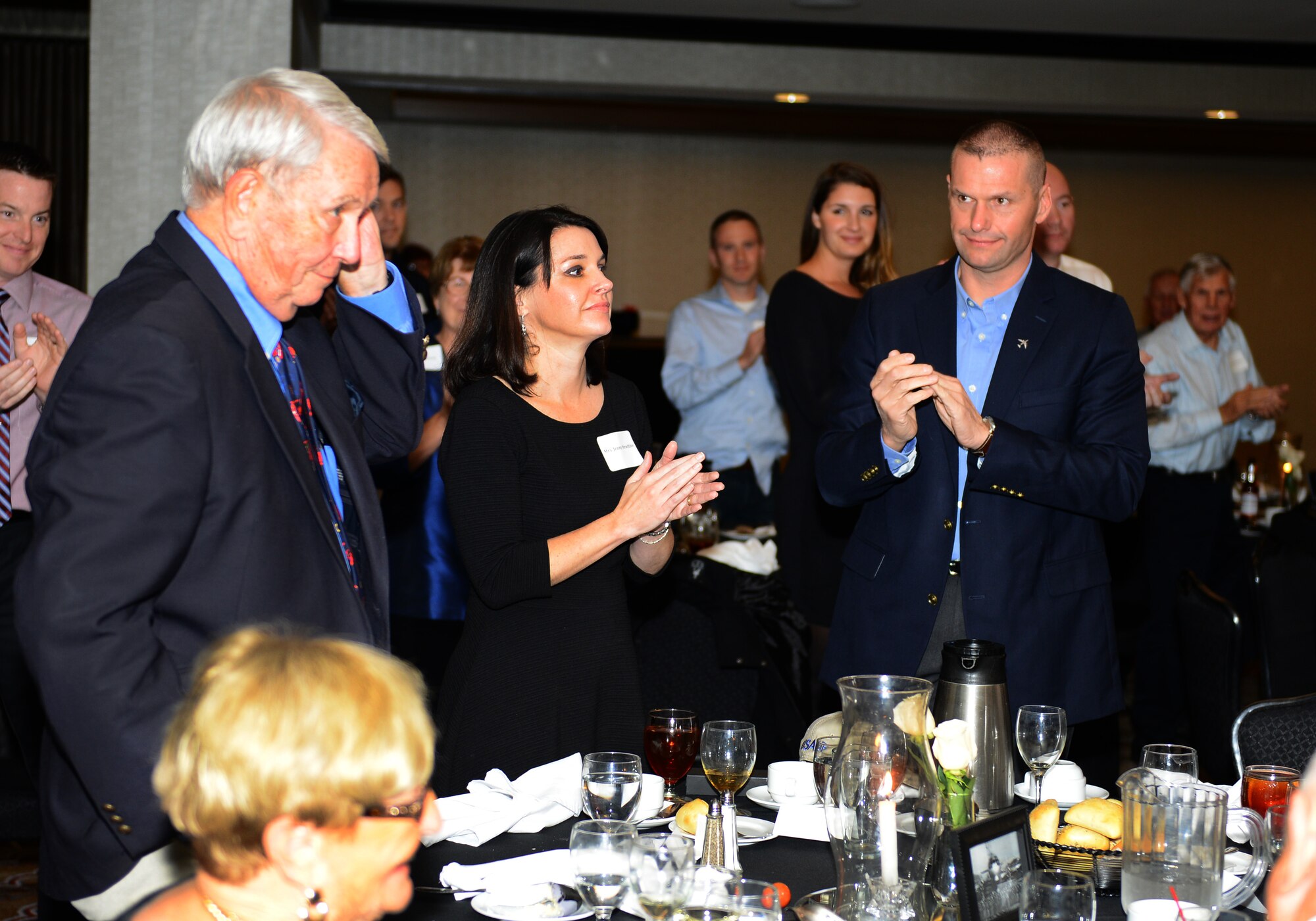 The attendants of the 384th Air Refueling Squadron reunion dinner recognize special guest, retired Gen. James Davis, former Squarepatcher, Oct. 24, 2015, at a hotel in Wichita, Kan. Davis began his career in the 384th flying the KC-97 Stratofreighter; later transitioning to fighter jets where he depended on aerial refueling capabilities to make it home after achieving the mission. (U.S. Air Force photo by Airman 1st Class Christopher Thornbury)