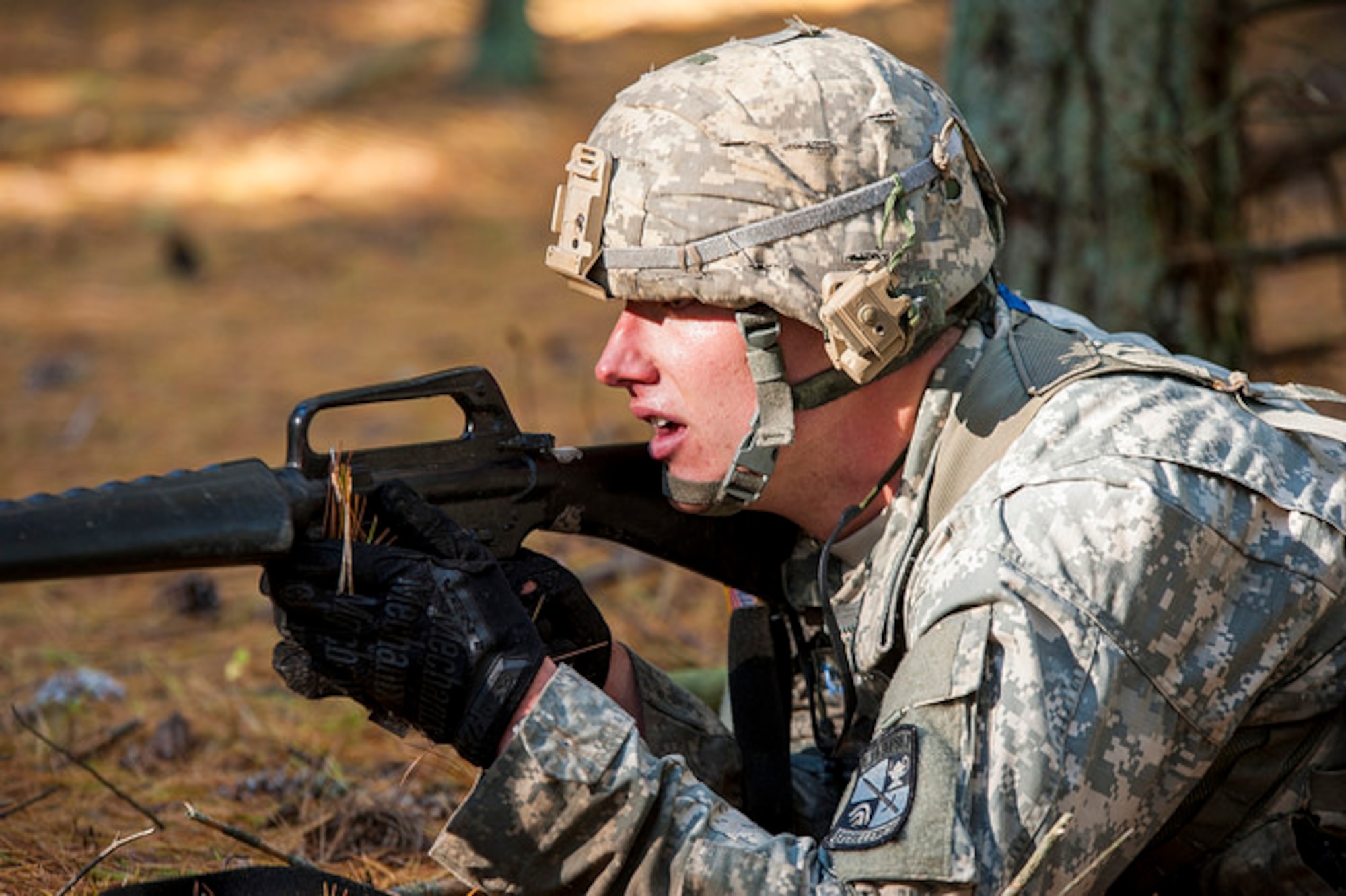 A cadet provides cover fire during the 2015 ROTC Ranger Challenge at Joint Base McGuire-Dix-Lakehurst, N.J., Oct. 17,2015. Forty-two colleges participated in 10 different events and the top nine-man team will compete in the Sandhurst Competition at West Point in 2016. (U.S. Air Force photo by 2nd Lt. Rachel Salpietra/Released)