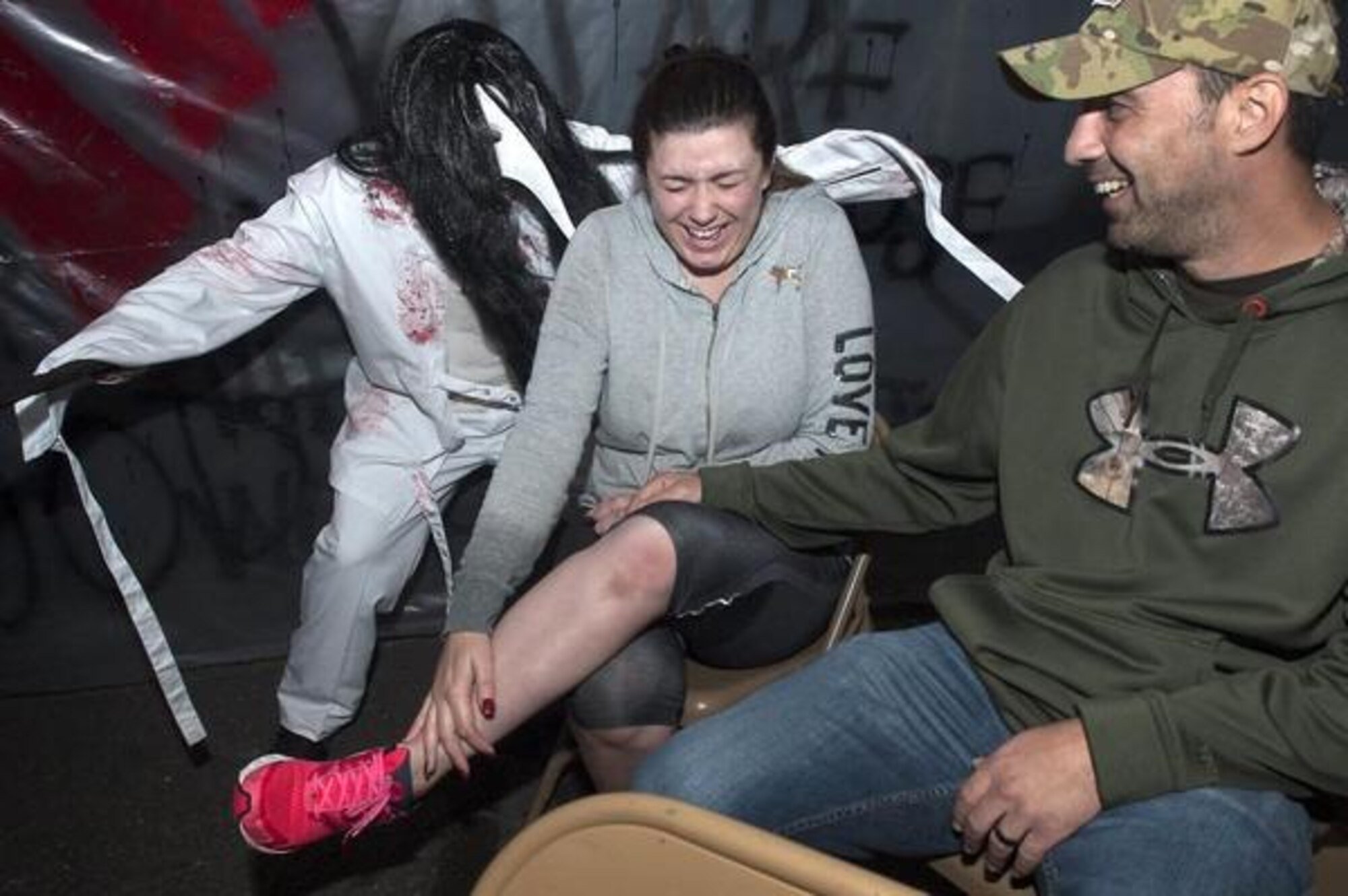 Tiffany and Rick Guzman, of DuPont, are greeted by a ghoulish “friend” Oct. 31, 2015, while visiting the 627th Civil Engineer Squadron’s “Haunted Asylum” on Joint Base Lewis-McChord.