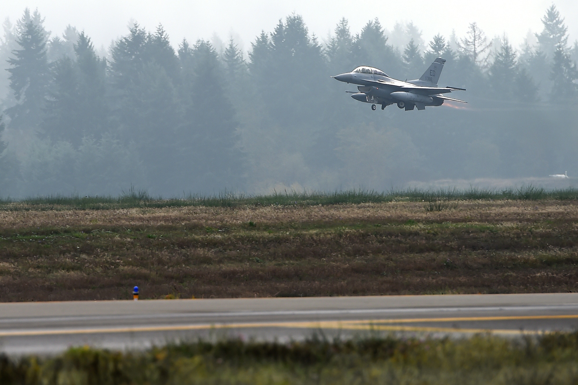An F-16 Falcon takes off on the McChord Field flightline Oct. 26, 2015 at Joint Base Lewis-McChord, Wash. The aircraft is here in support of the KC-46 Pegasus flight test program for the next 16-to-18 months. (U.S. Air Force photo/Senior Airman Naomi Shipley) 