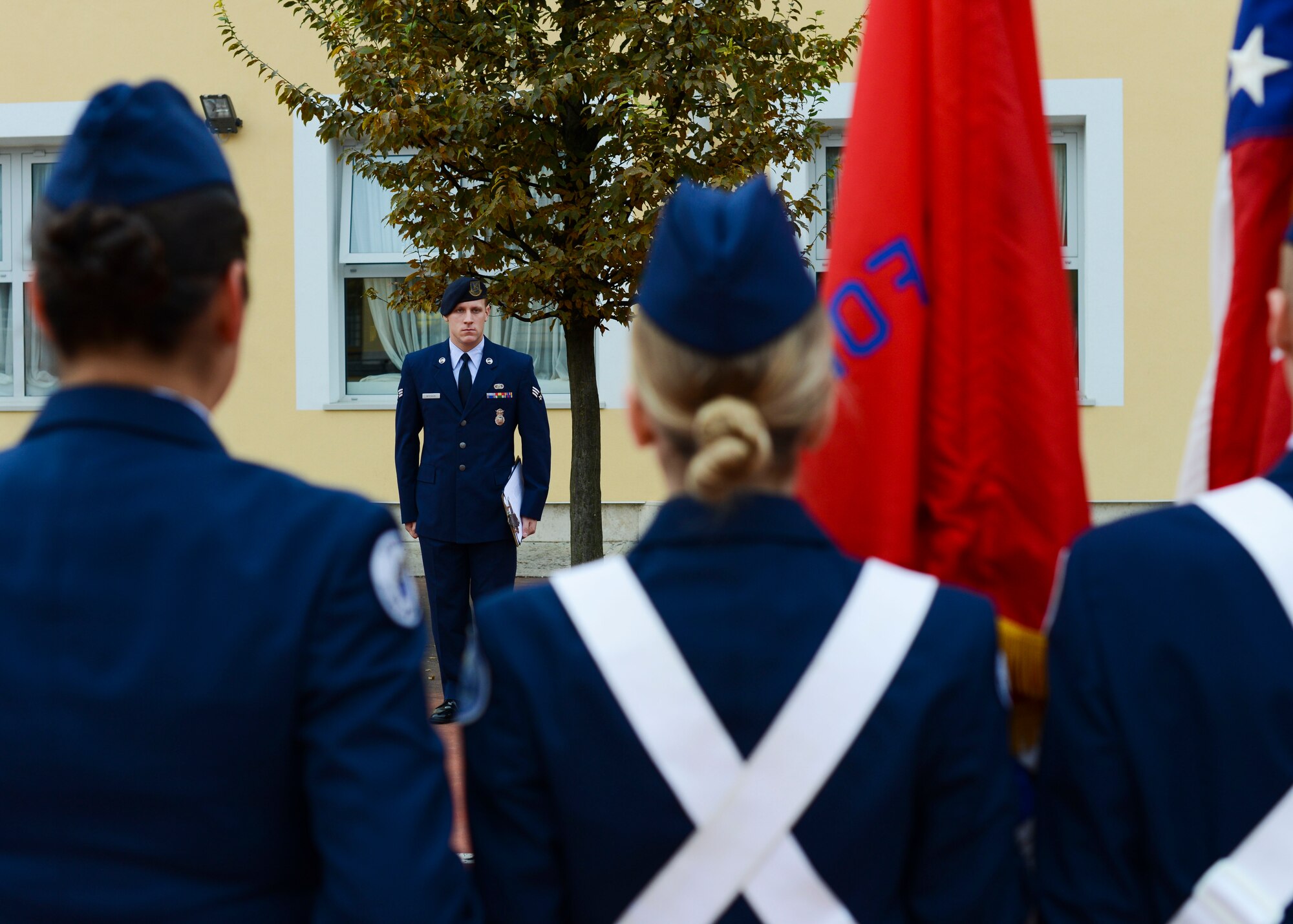 U.S. Air Force Senior Airman Michael Wychock, 31st Security Forces Squadron vehicle control officer, commands cadets during the Aviano High School JROTC Corps Day, Oct. 28, 2016, at Aviano Air Base, Italy. Wychock and other volunteers judged drill, color guard, dress and appearance and flag detail events to prepare the cadets for a Nov. 14 drill competition. (U.S. Air Force photo by Senior Airman Austin Harvill/Released)