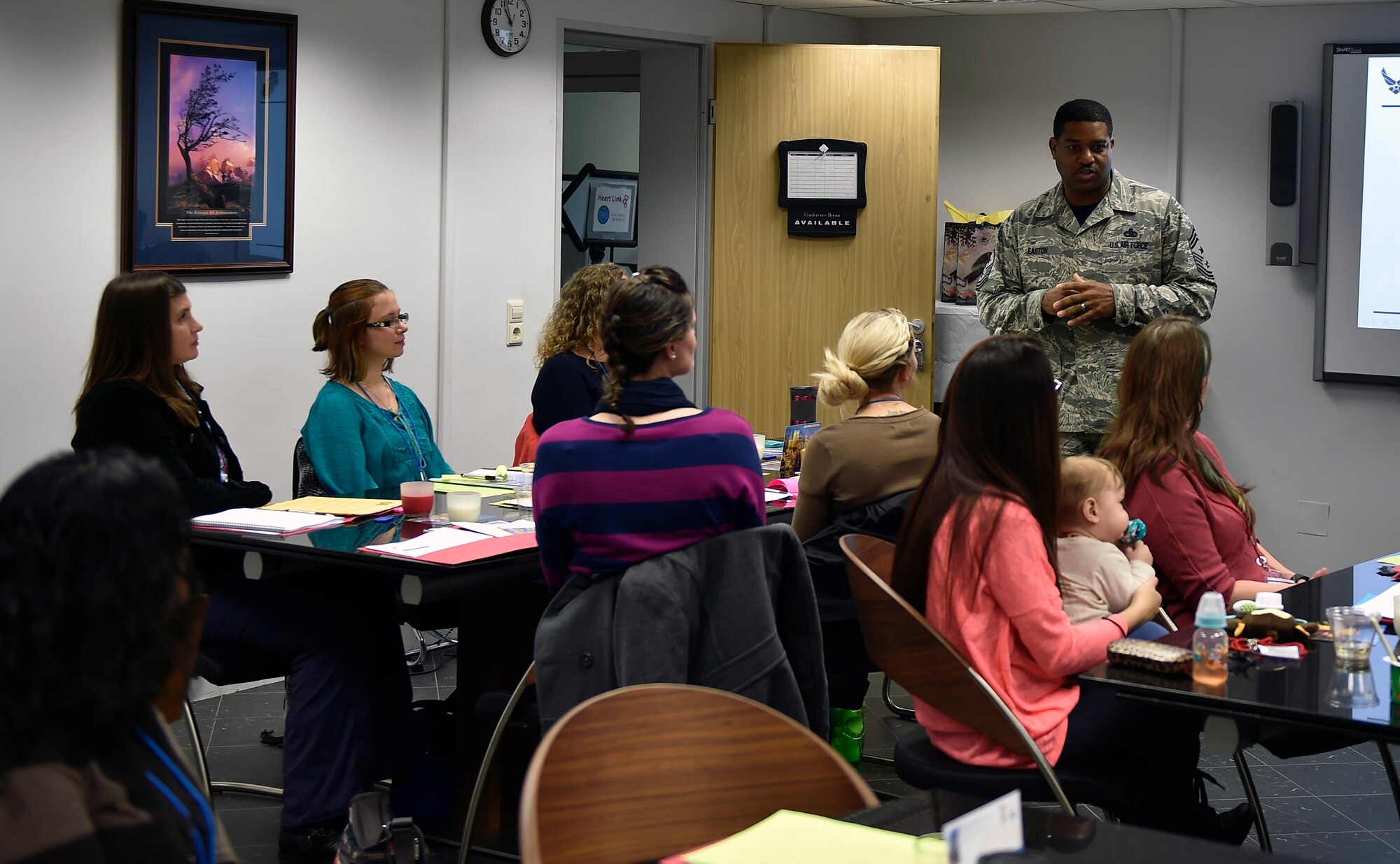 Chief Master Sgt. Phillip L. Easton, 86th Airlift Wing command chief, talks to spouses graduating from the HeartLink program at the Ramstein Airman & Family Readiness Center, Oct. 23, 2015. The goal of HeartLink is to strengthen Air Force families through knowledge about military programs, agencies and the mission. (U.S. Air Force photo/Senior Airman Damon Kasberg)
