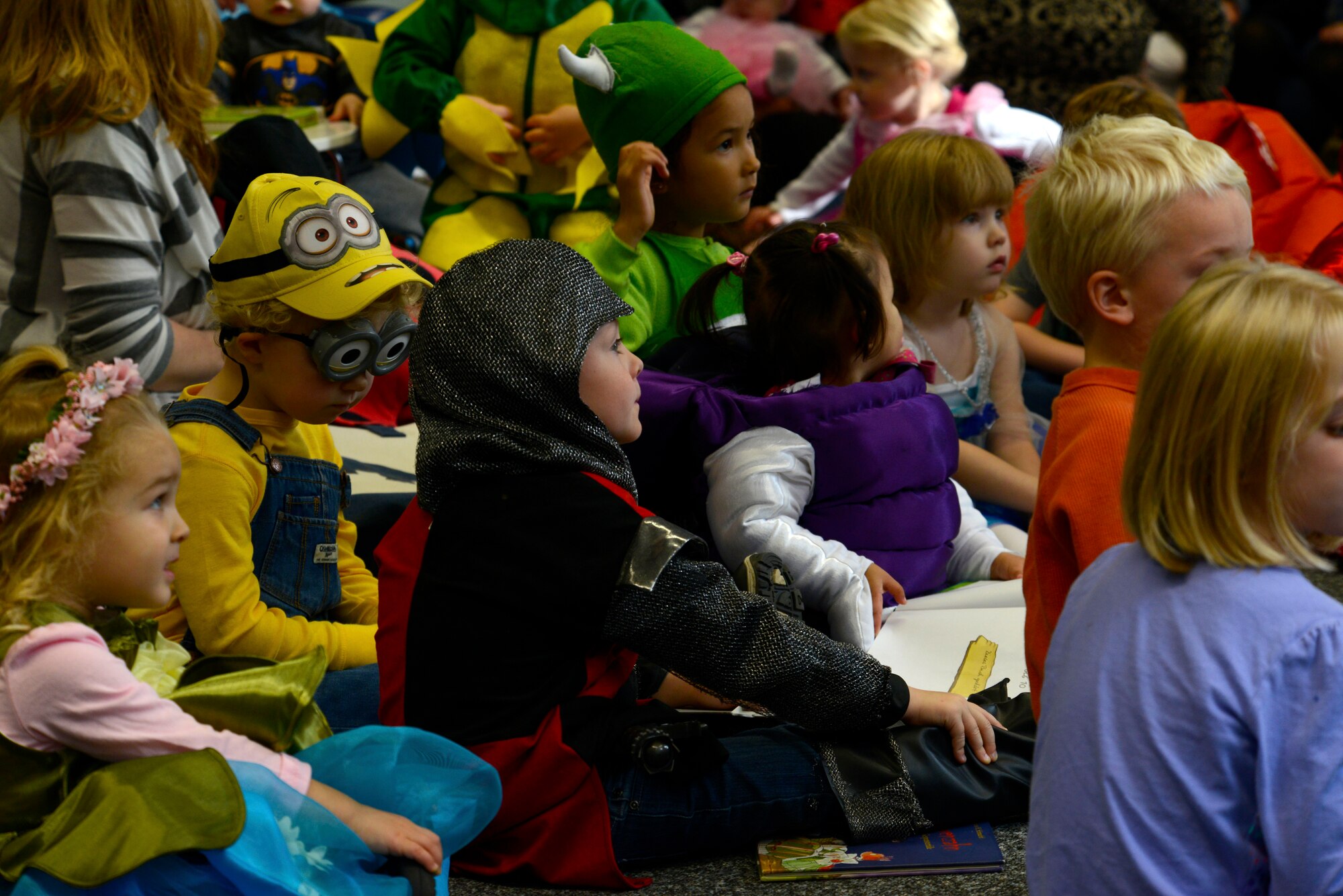 Kaiserslautern Military Community children listen to a story during the Ramstein Library’s Spooky Story Time Oct. 29, 2015, at Ramstein Air Base, Germany. The children were encouraged to wear a Halloween costume to the event. (U.S. Air Force photo/Airman 1st Class Tryphena Mayhugh)