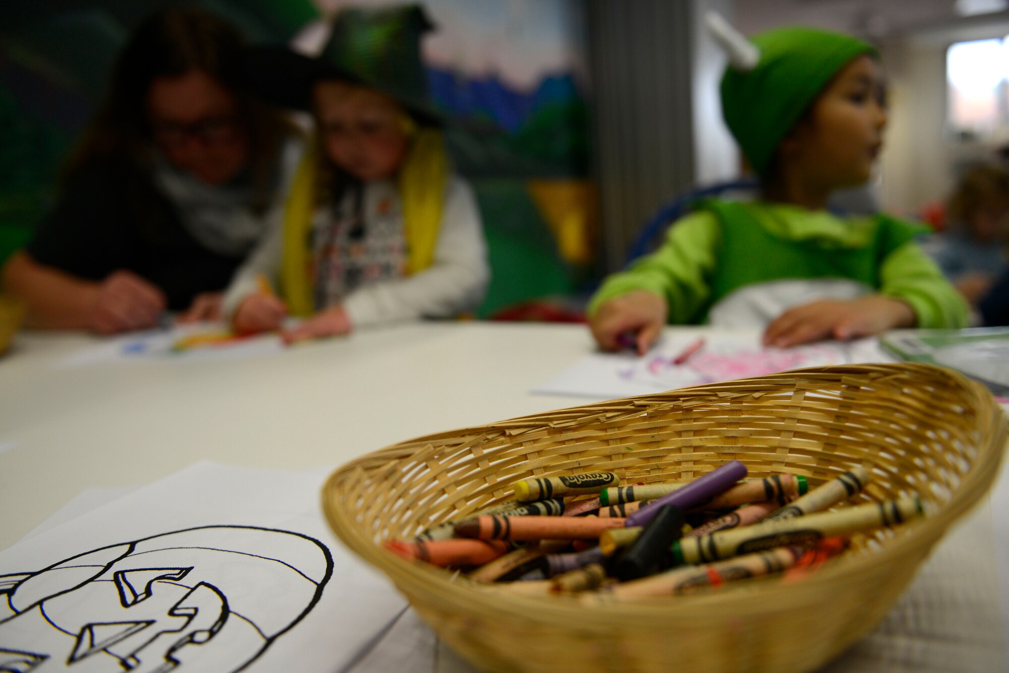 A bowl of crayons lies on a table for Kaiserslautern Military Community children to use to color a picture of a pumpkin at the Ramstein Library’s Spooky Story Time Oct. 29, 2015, at Ramstein Air Base, Germany. The children listened to two Halloween-themed stories, colored a picture and painted their handprints on pumpkins. (U.S. Air Force photo/Airman 1st Class Tryphena Mayhugh)