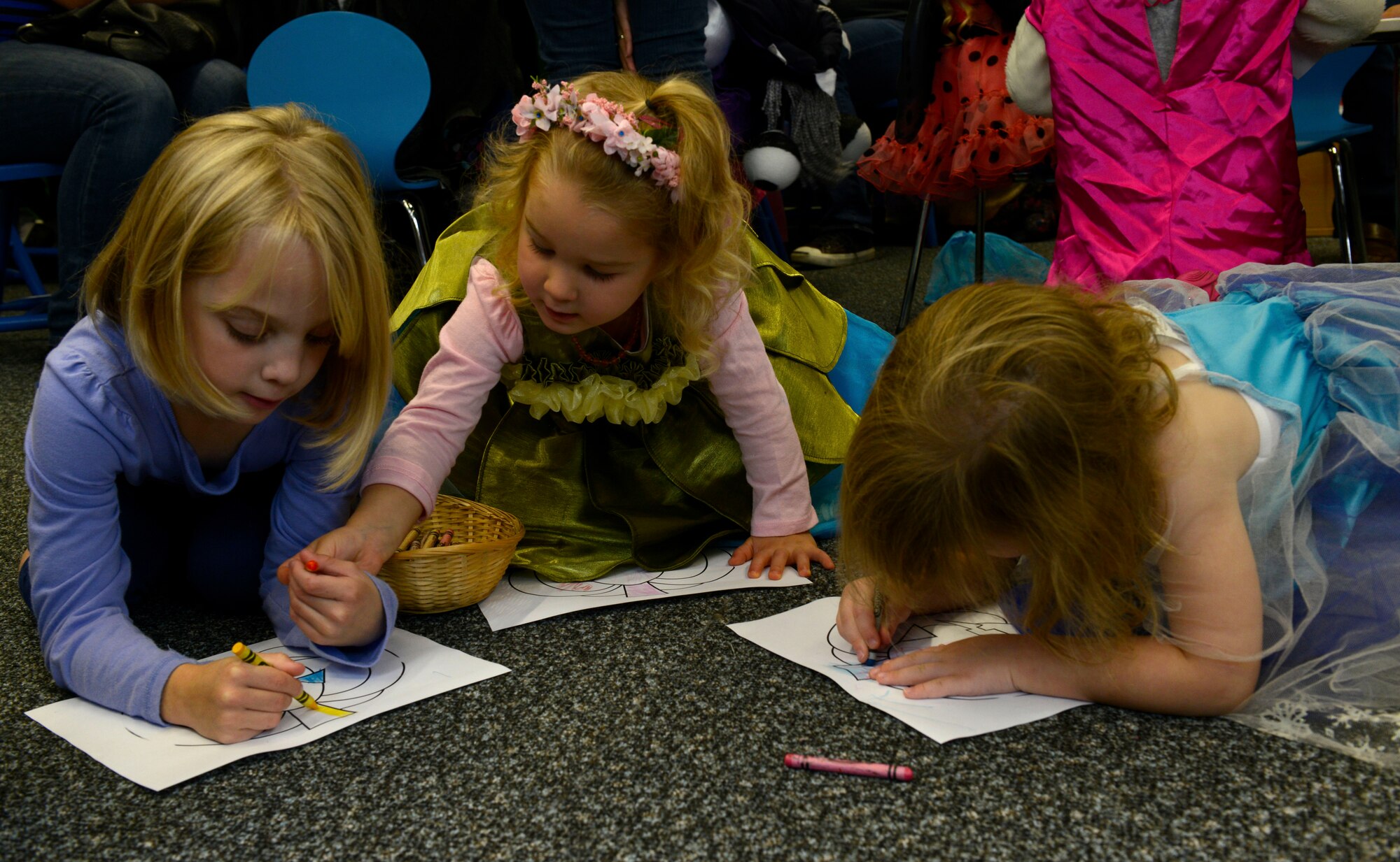 Kaiserslautern Military Community children color a picture of a pumpkin at the Ramstein Library’s Spooky Story Time Oct. 29, 2015, at Ramstein Air Base, Germany. The children were encouraged to wear costumes and were read two Halloween-themed stories. (U.S. Air Force photo/Airman 1st Class Tryphena Mayhugh)
