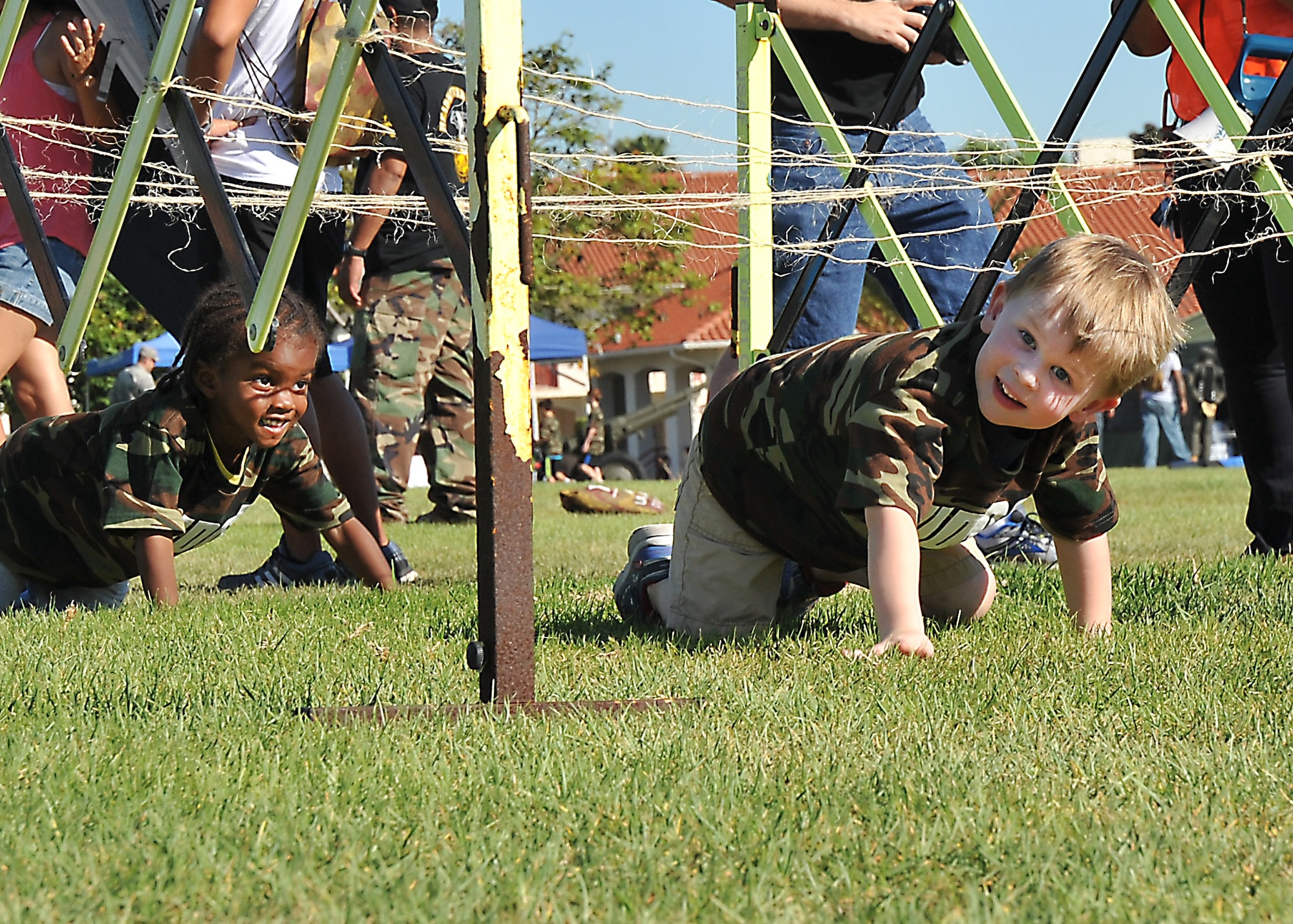 Racing through an obstacle course featuring barbed wire  give military children a better understanding of deployments during the annual Kids Understanding Deployment Operations event, Oct. 24, on the Los Angeles Air Force Base parade grounds at Fort MacArthur in San Pedro, Calif. More than 150 military, DoD and contractor’s children and teens experienced first-hand what their military parent’s experience when deployed. (U.S. Air Force photo/Joseph Juarez, Sr.) 