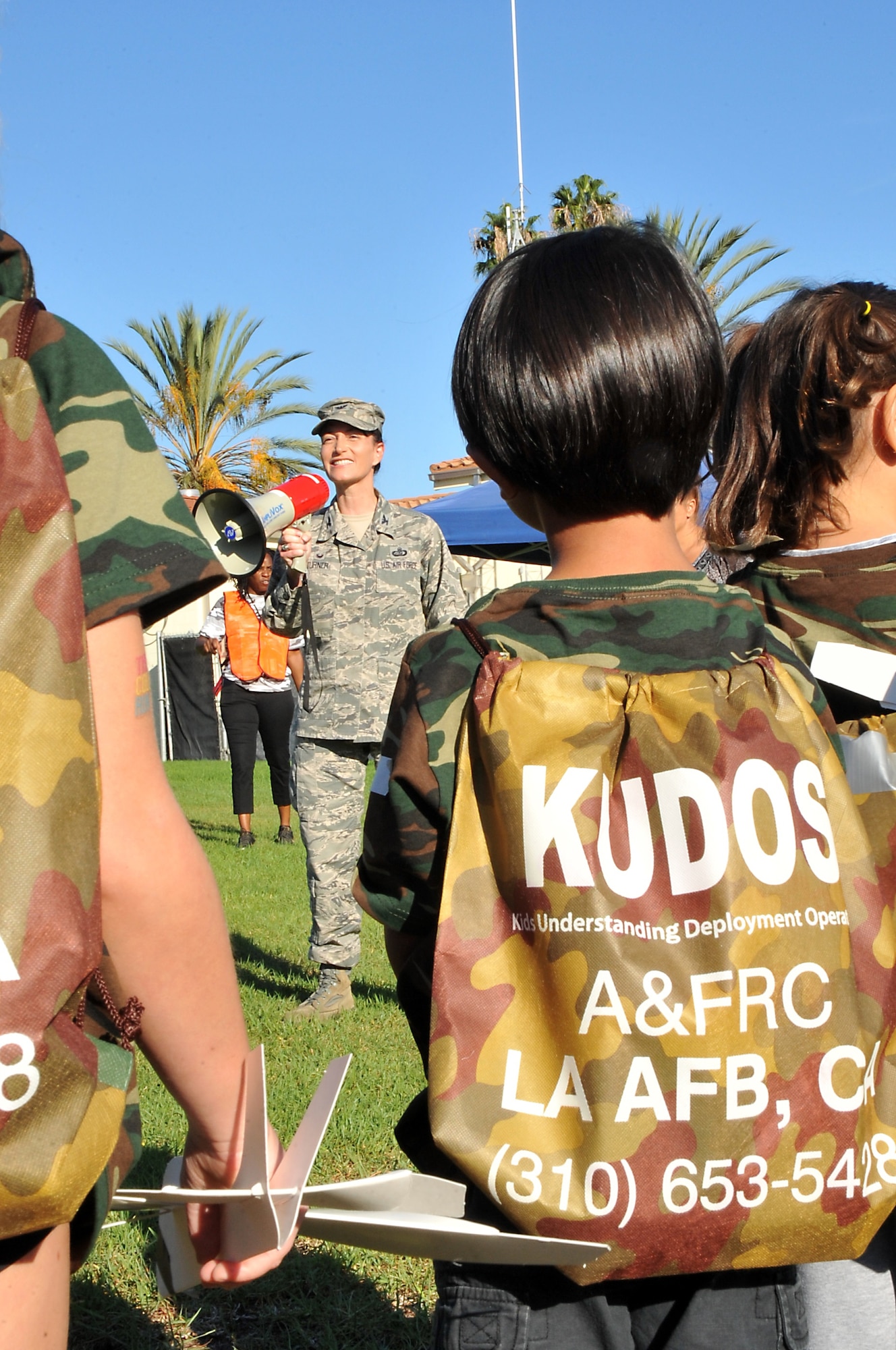 A young warrior listens to an intelligence briefing by Col. Donna Turner, 61st Air Base Group commander, during the annual Kids Understanding Deployment Operations event, Oct. 24, on the Los Angeles Air Force Base parade grounds at Fort MacArthur in San Pedro, Calif. More than 150 military, DoD and contractor’s children and teens experienced first-hand what their military parents experience when deployed. (U.S. Air Force photo/Joseph Juarez, Sr.) 