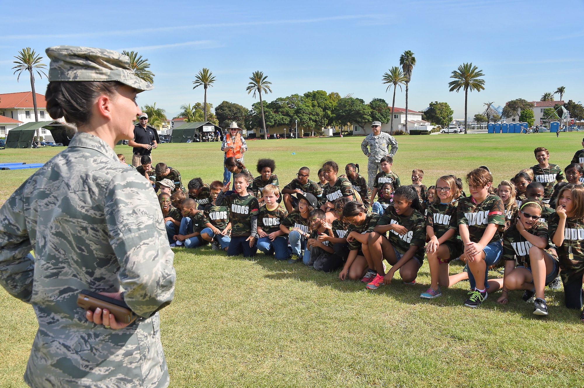 A group of children listen intently to an intelligence briefing by Col. Donna Turner, 61st Air Base Group commander, during the annual Kids Understanding Deployment Operations event, Oct. 24, on the Los Angeles Air Force Base parade grounds at Fort MacArthur in San Pedro, Calif. More than 150 military, DoD and contractor’s children and teens experienced first-hand what their military parents experience when deployed. (U.S. Air Force photo/Joseph Juarez, Sr.) 
