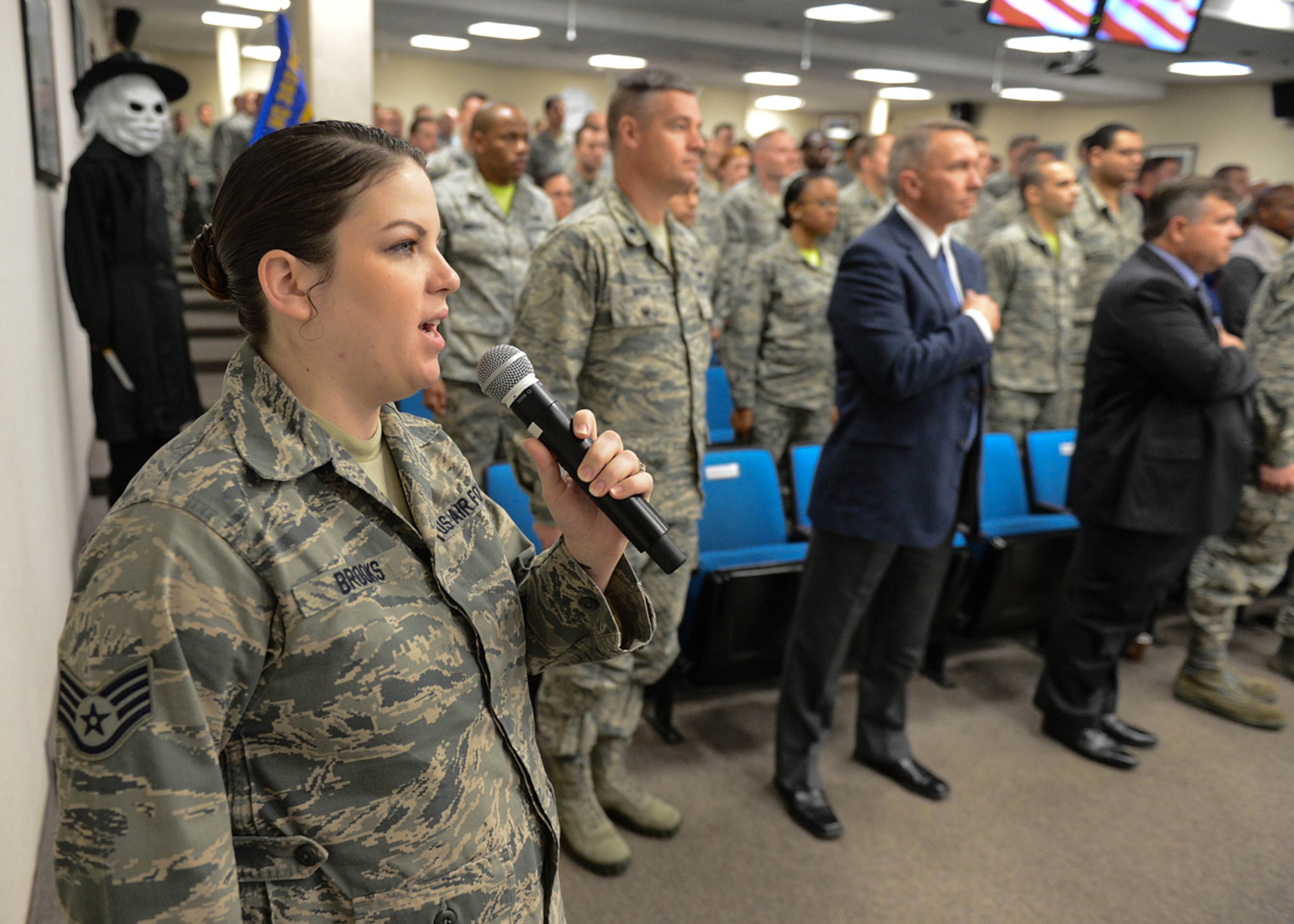 Staff Sgt. Marjorie Brooks, 319th Recruiting Squadron personnelist, sings the national anthem during the Team Hanscom Quarterly Awards Ceremony at the conference center Oct. 30. Nominees from the 319th Recruiting Squadron, 66th Air Base Group, Battle Management and C3I and Network Directorates, Joint Personal Property Shipping Office-Northeast and Contracting Directorate competed in several military, civilian and team categories. (U.S. Air Force photo by Jerry Saslav)
