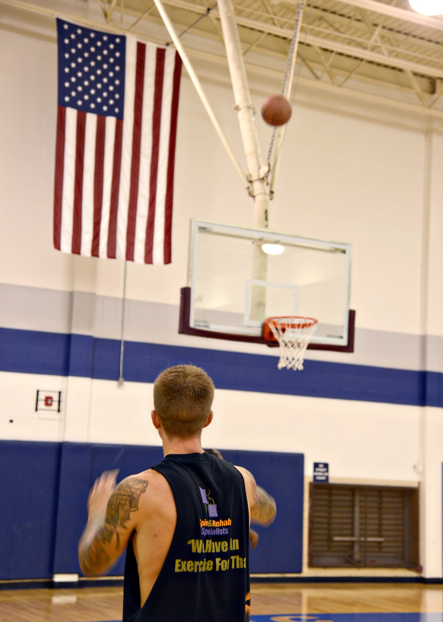 Robin Uptain, U.S. Army retired, aims for a 3-point goal during the 3-point basketball competition as part of the Oct. 21 grand reopening activities at the Gerrity Fitness and Sports Center. (Air Force photo by Kelly White/Released)