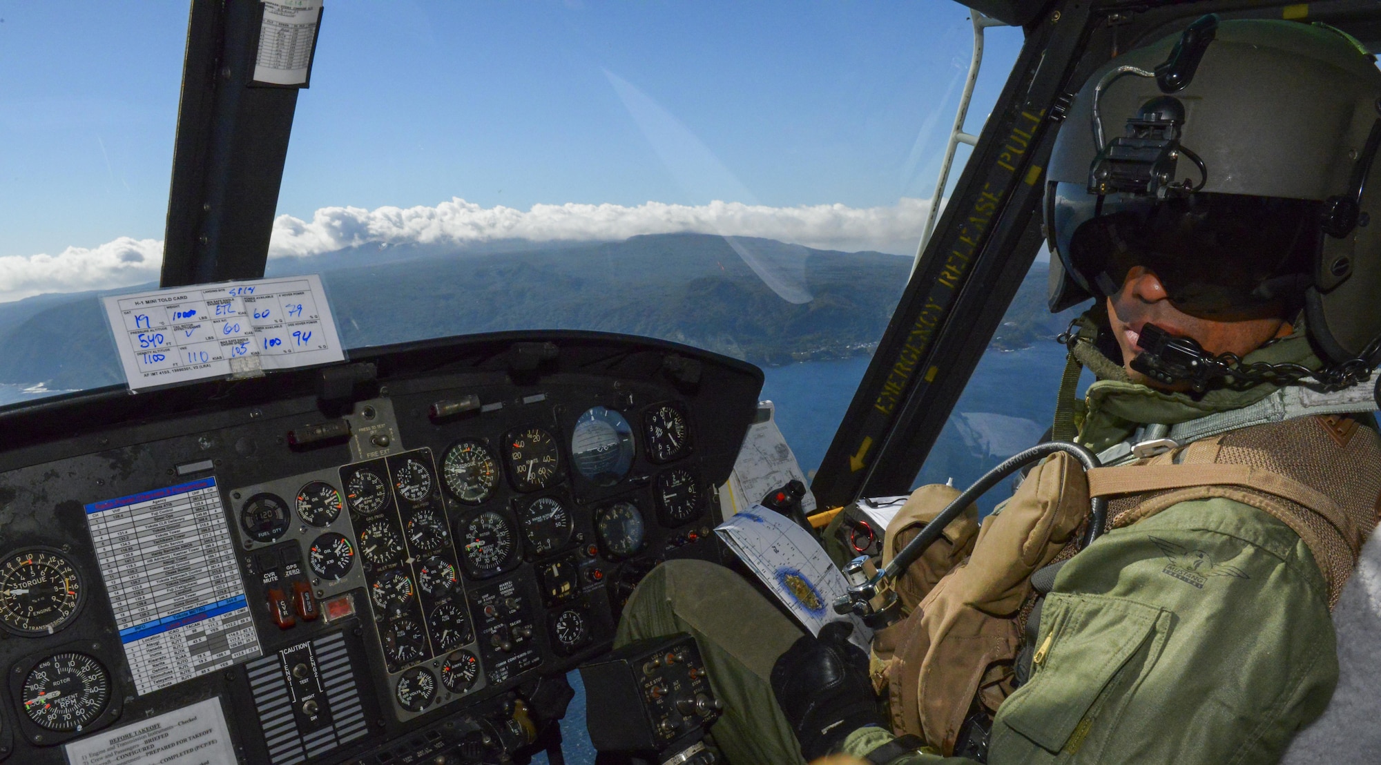 Capt. Brandon Jones, 459th Airlift Squadron chief of standardization and evaluation, pilots a UH-1N Huey off the coast of Tokyo, Japan, Oct. 28, 2015. The crew delivered simulated medical supplies to Miakejima Island showcasing Yokota’s ability to augment the Tokyo Metropolitan Government’s disaster relief efforts. (U.S. Air Force photo by Airman 1st Class Elizabeth Baker/Released)
