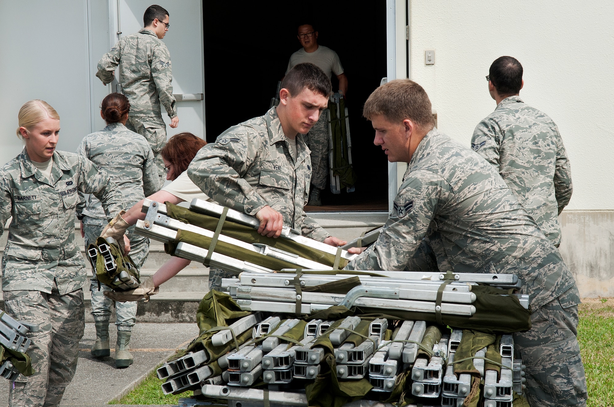 Augmentees from the 18th Wing pack up after the non-combatant evacuation operation exercise concluded at the Risner Fitness Center on Kadena Air Base, Japan, Oct. 28, 2015. As the Keystone of the Pacific, constant readiness is critical to accomplishing Kadena’s mission of providing support to allies in the Indo-Asia-Pacific region. (U.S. Air Force photo by Airman 1st Class Nicholas Emerick)