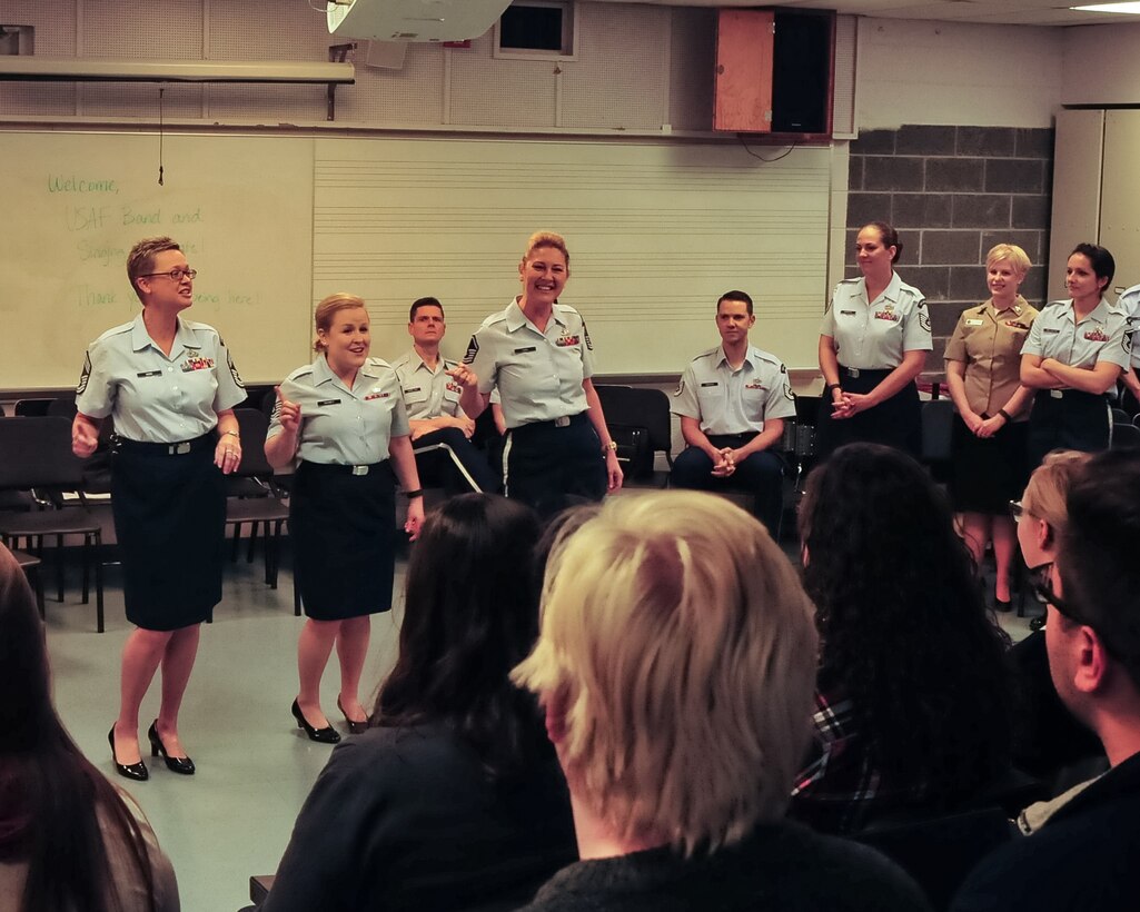 Chief Master Sgt. Angela Burns, Technical Sgt. Hannah Shirey and Master Sgt. Janice Carl perform an Andrews Sister’s selection as members of the Singing Sergeants look on. The performance was part of a vocal seminar for students of Central Connecticut State University in New Britain, Conn. (Photo by A1C Latasia Gross/released)