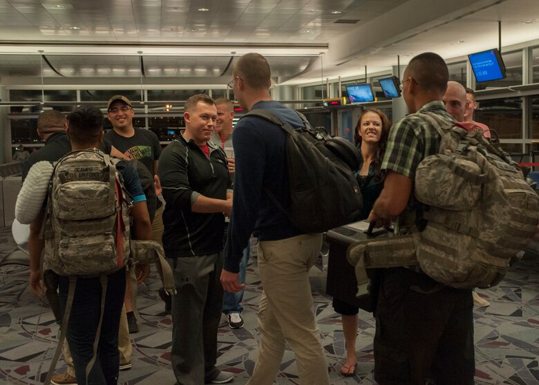 Members from the 926th Security Forces Squadron are greeted after returning from a seven-month deployment at McCarran International Airport in Las Vegas, Oct. 22, 2015. Along with family members, Col. Ross Anderson, 926th Wing commander, was present to greet the returning Airmen. (U.S. Air Force photo by Airman 1st Class Jake Carter)