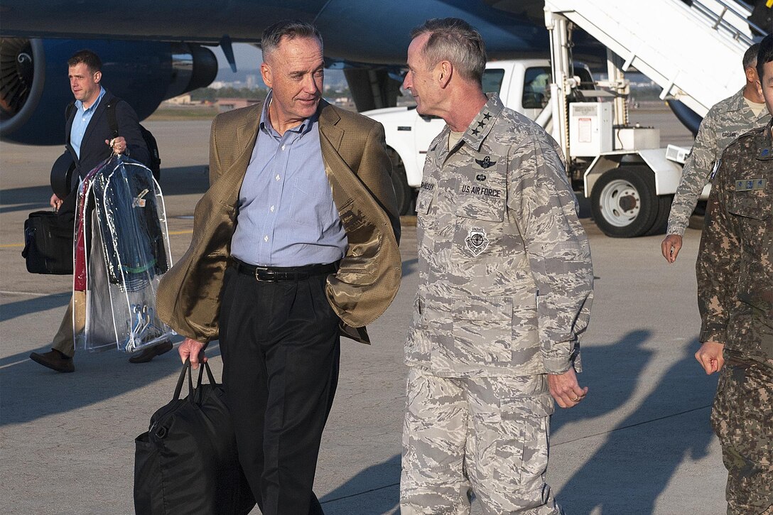 Marine Corps Gen. Joseph F. Dunford Jr., chairman of the Joint Chiefs of Staff, speaks with Lt. Gen. Terrence O'Shaughnessy, commander of 7th Air Force and Air Component Command, U.S. Forces Korea/U.S. Combined Forces, after landing at Osan Air Base, Republic of Korea, Oct. 31, 2015. DoD photo by Navy Petty Officer 2nd Class Dominique A. Pineiro