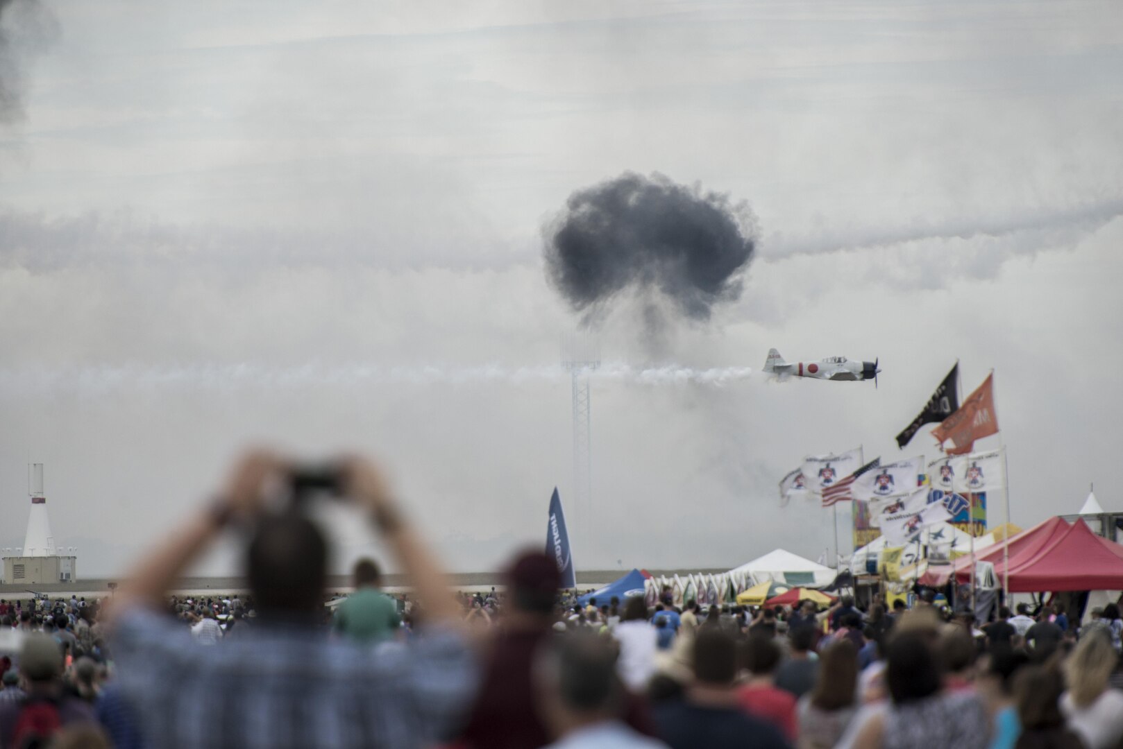 Visitors at the Joint Base San Antonio Air Show and Open House watch the Tora! Tora! Tora! Demonstration Oct. 31, 2015, at Joint Base San Antonio-Randolph, Texas. Air shows allow the public to see front-line military hardware and experience the precision and professionalism of the Air Force.